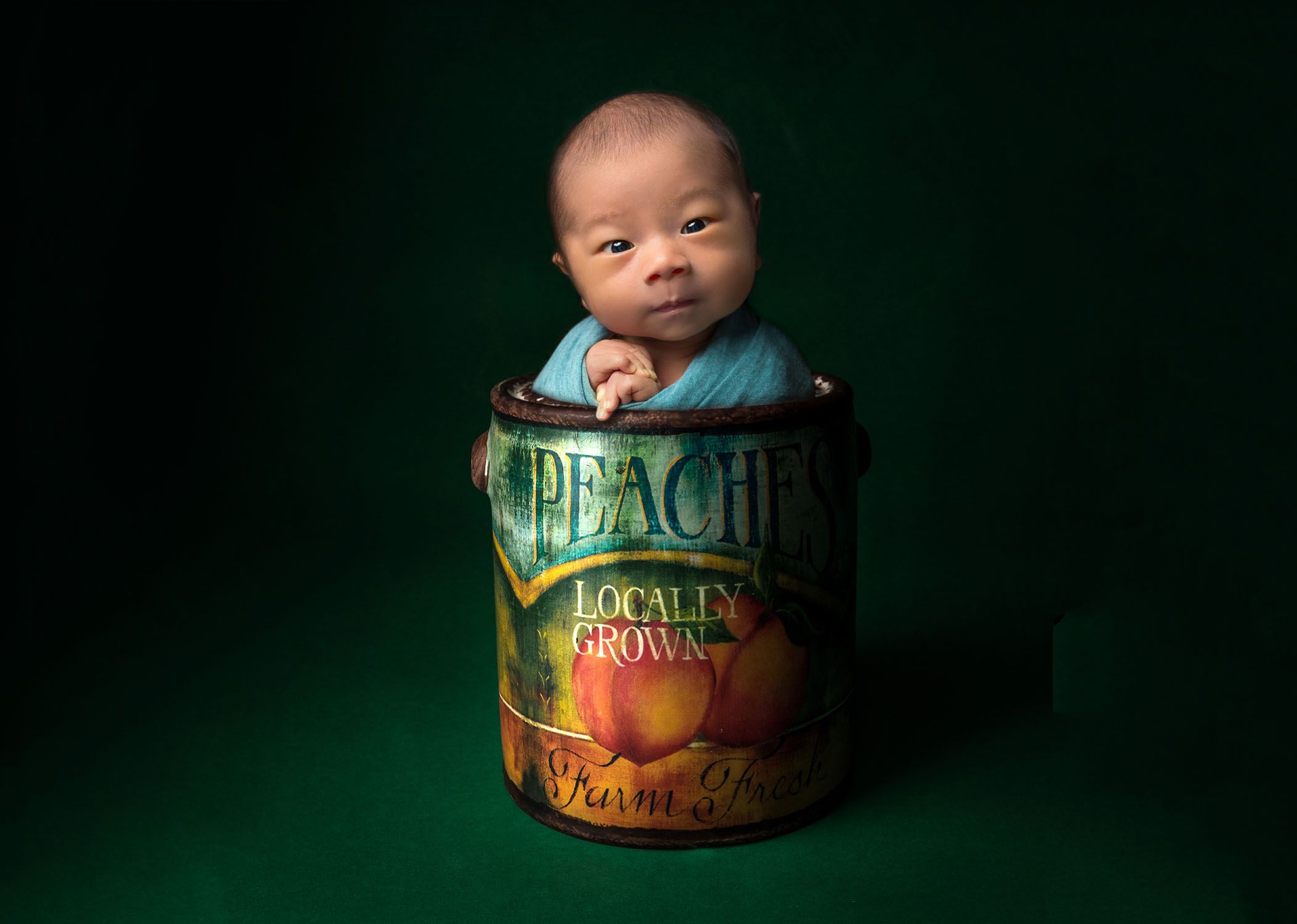 Newborn Photographer CT newborn baby wide awake in a can on peaches