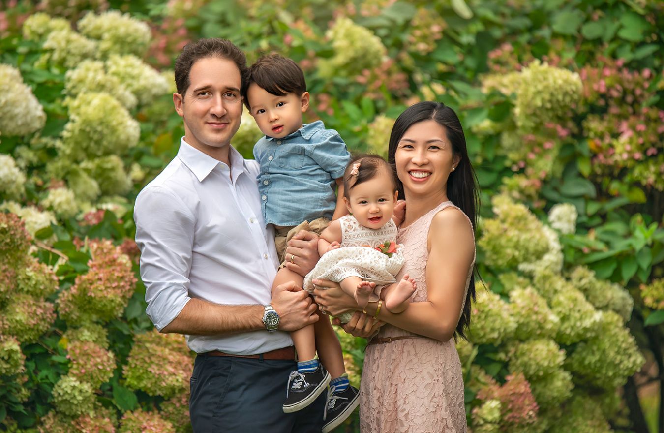 Family Photographer CT beautiful family of four with Dad, Mom, little boy and baby girl in front of blooming hydrangea