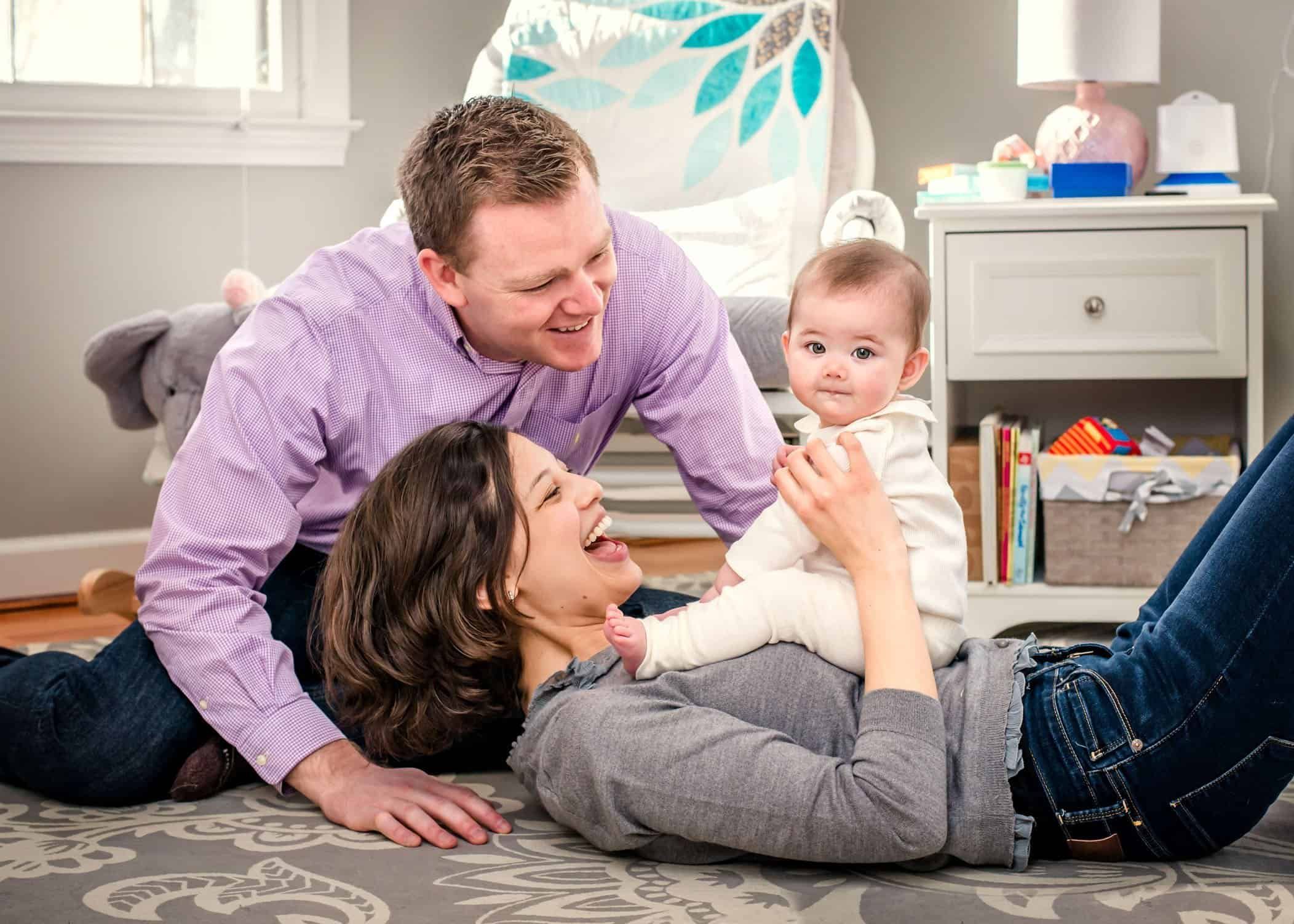 6 month old baby playing with her parents in her nursery Glastonbury CT Baby Photographer One Big Happy Photo www.onebighappyphoto.com/babies