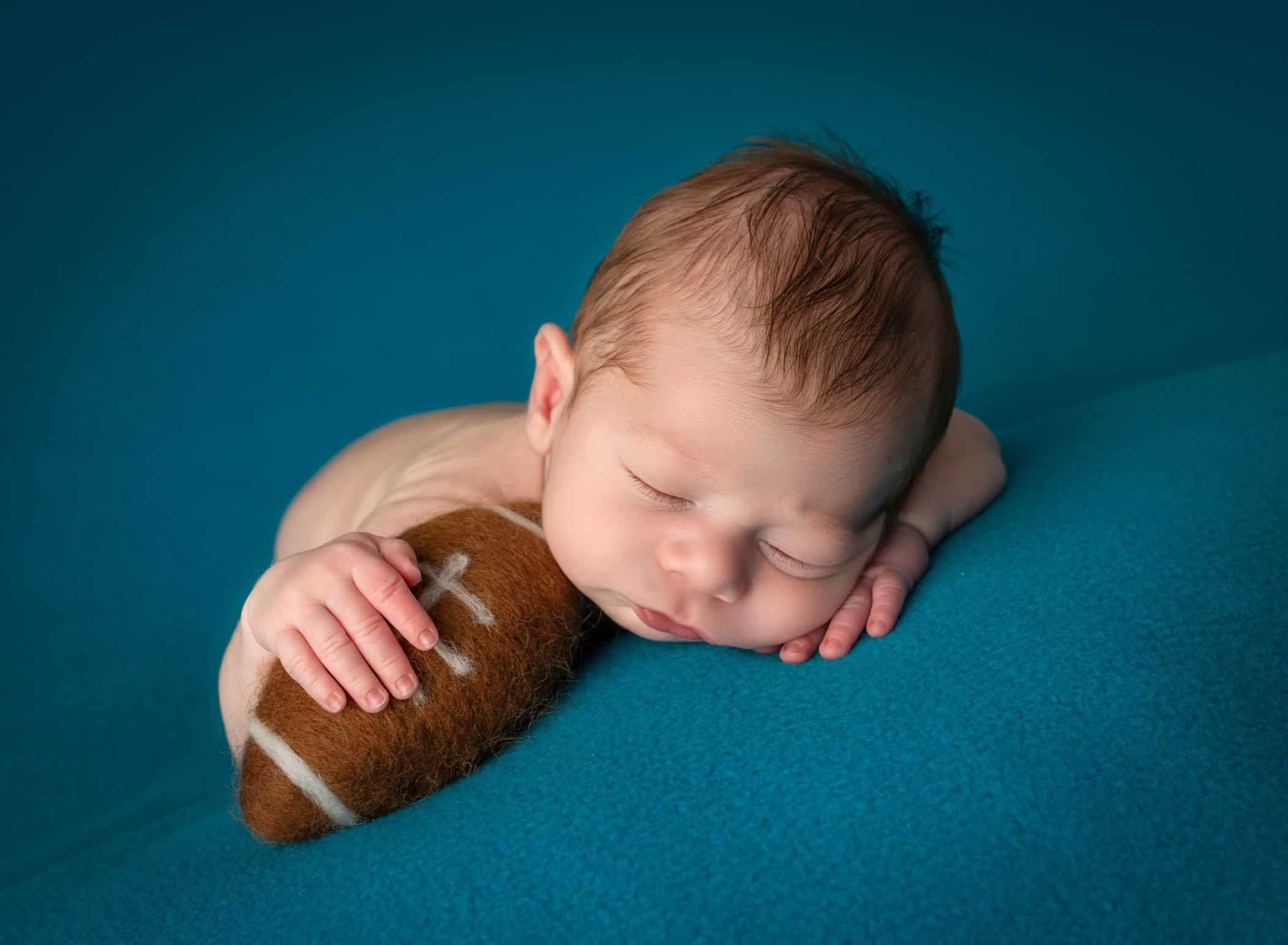 newborn baby boy sleeping with a football tucked underneath his hand newborn baby boy sleeping with a football tucked underneath his hand newborn baby boy sleeping with a football tucked underneath his hand newborn baby boy sleeping with a football tucked underneath his hand