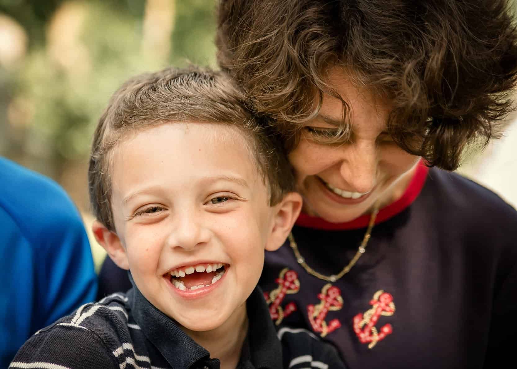 young son and Mom sharing a good laugh outside