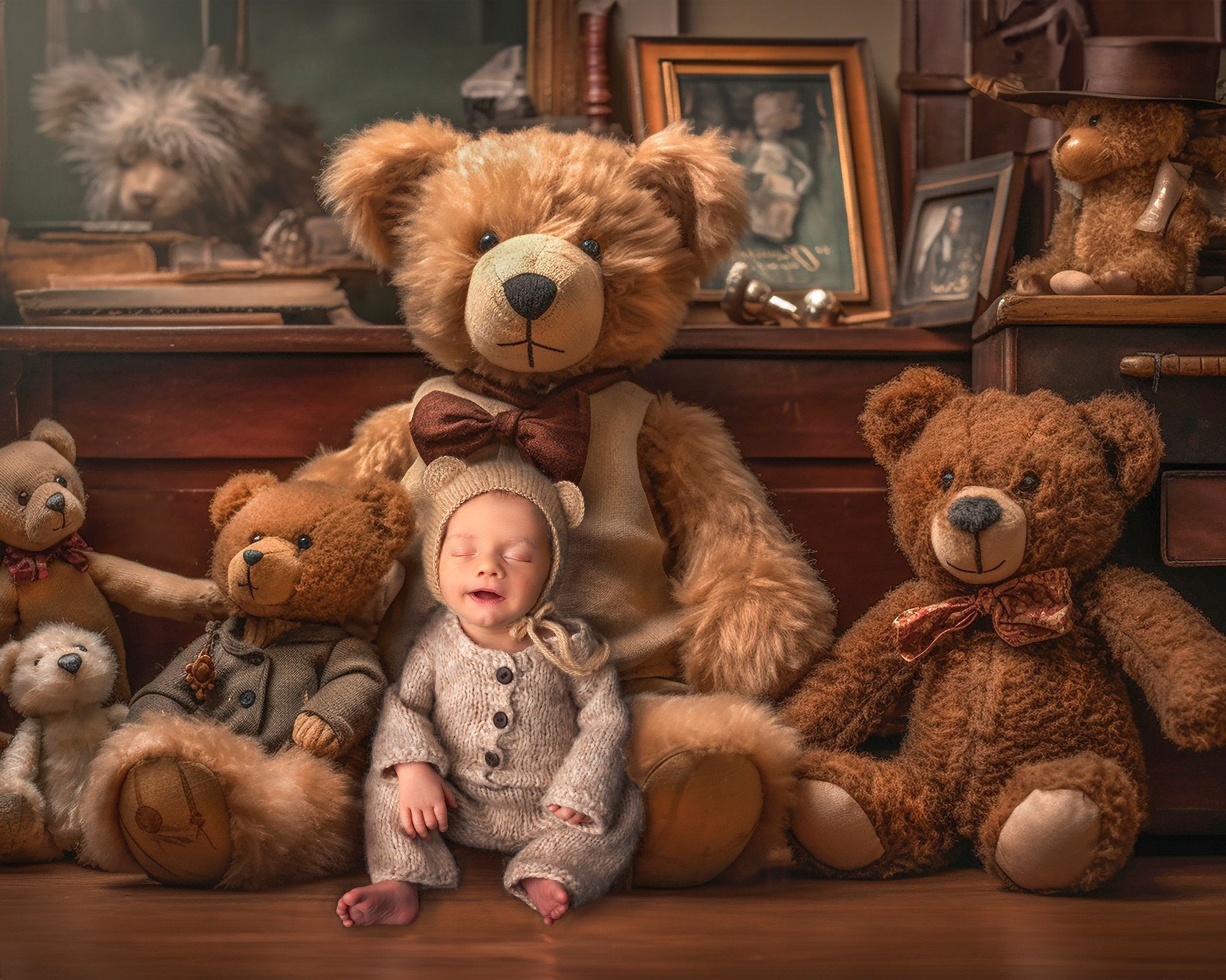 smiling newborn newborn baby boy sitting surrounded by teddy bears