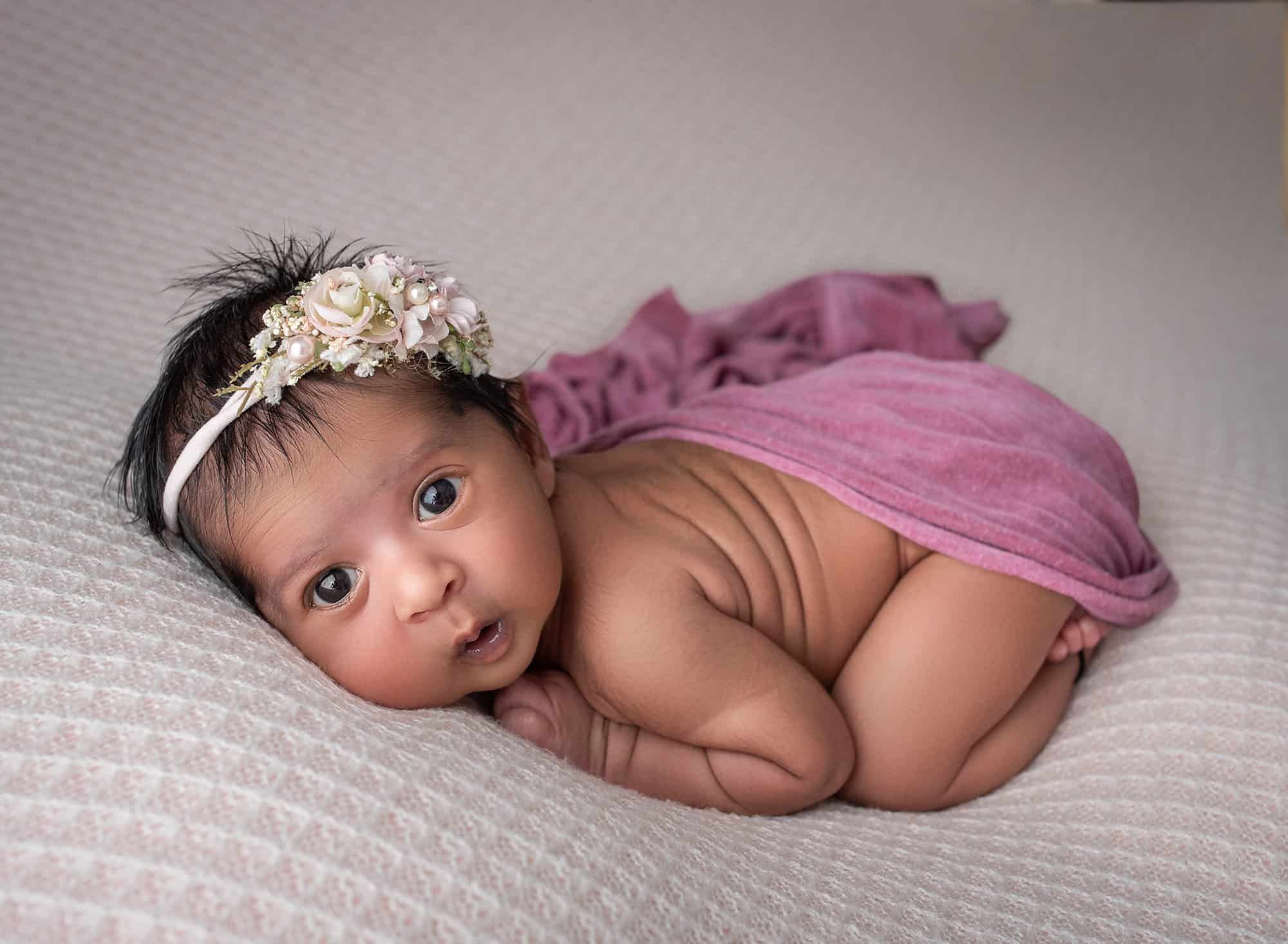 brunette newborn baby girl wide awake