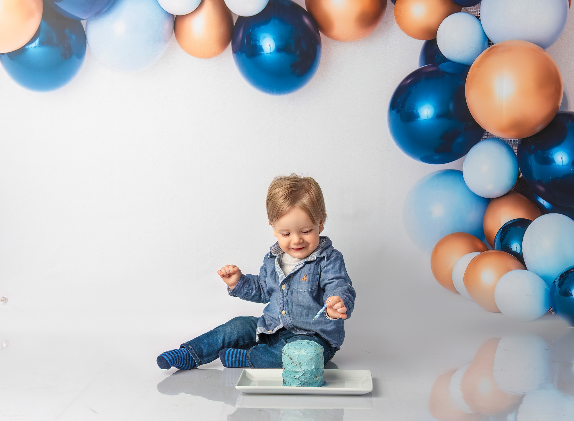 Bryce removing an unlit candle from his blue cake