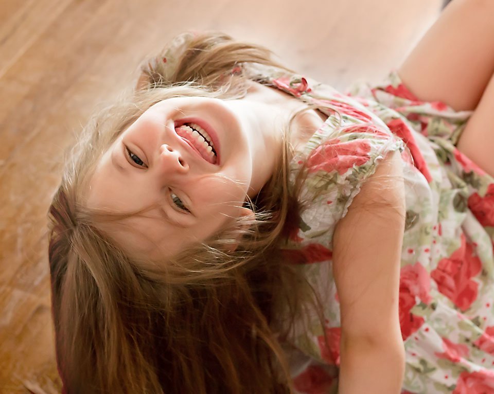 little girl bending backwards smiling
