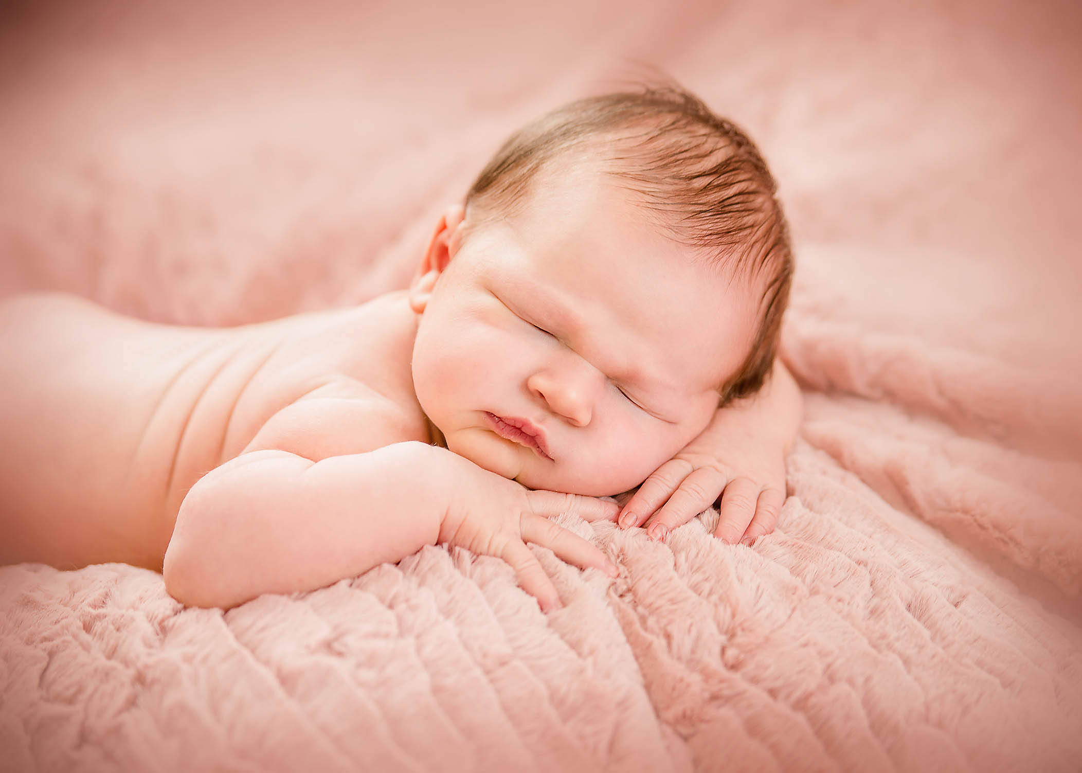4 days old newborn girl laying on pink blanket