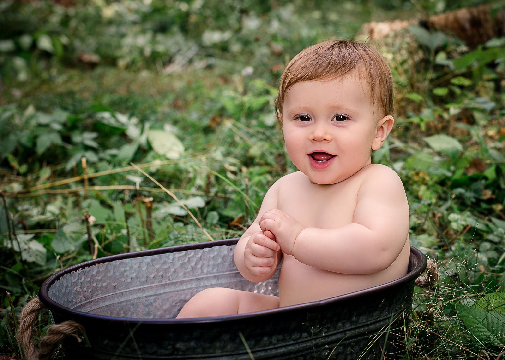 9 mo old baby boy sitting in a tin bathtub outside One Big Happy Photo
