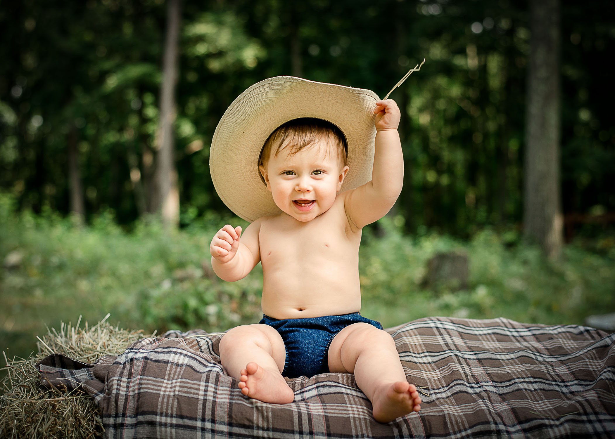 9 mo old baby boy with cowboy hat on sitting outside One Big Happy Photo