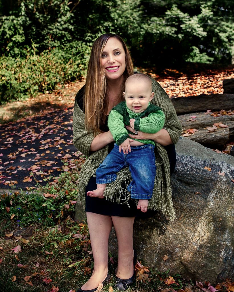 Mom and her 6 month old son posing for on a big rock in the garden One Big happy Photo