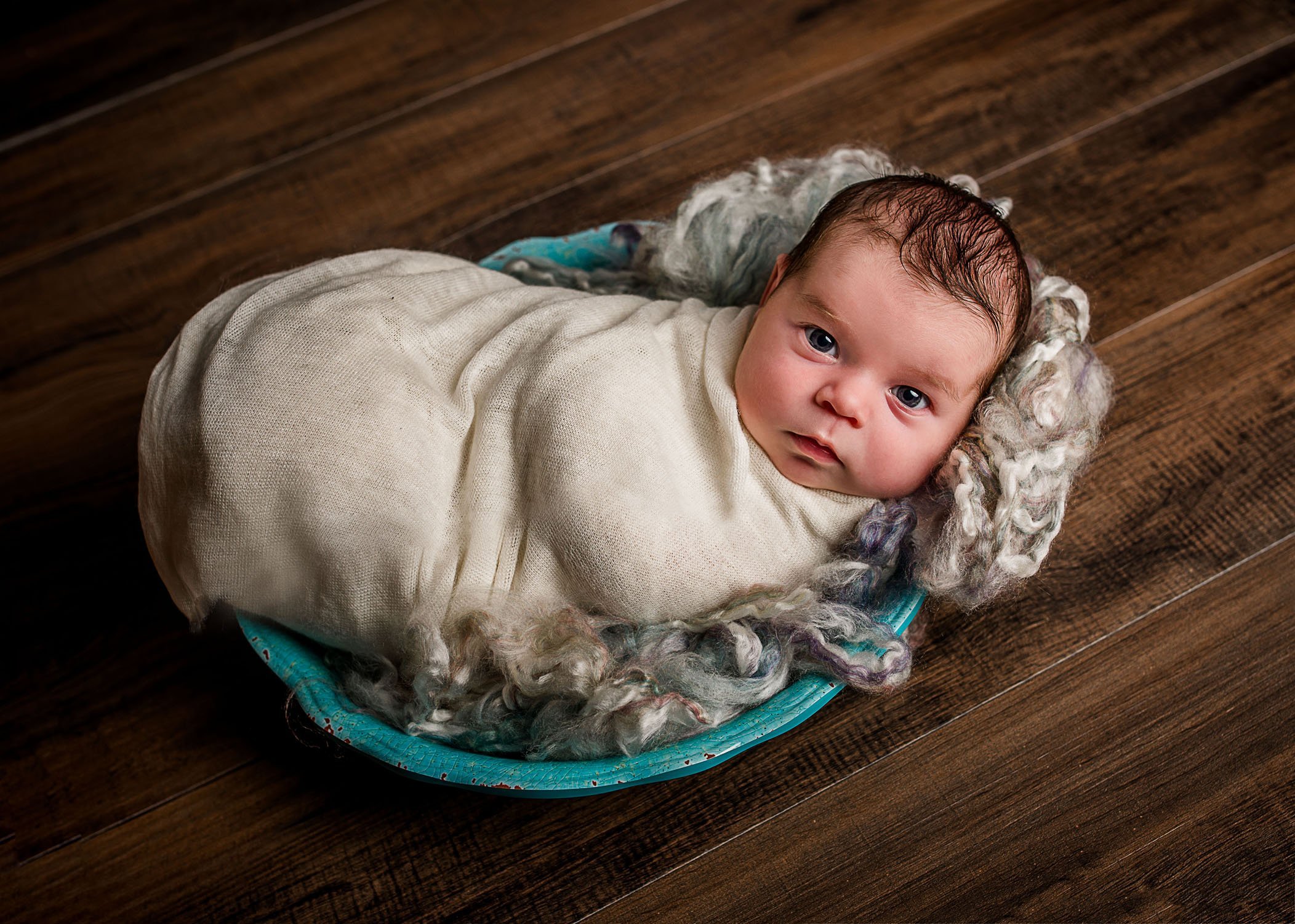 newborn baby girl wrapped in bowl awake and looking at camera One Big Happy Photo Amber Sehrt