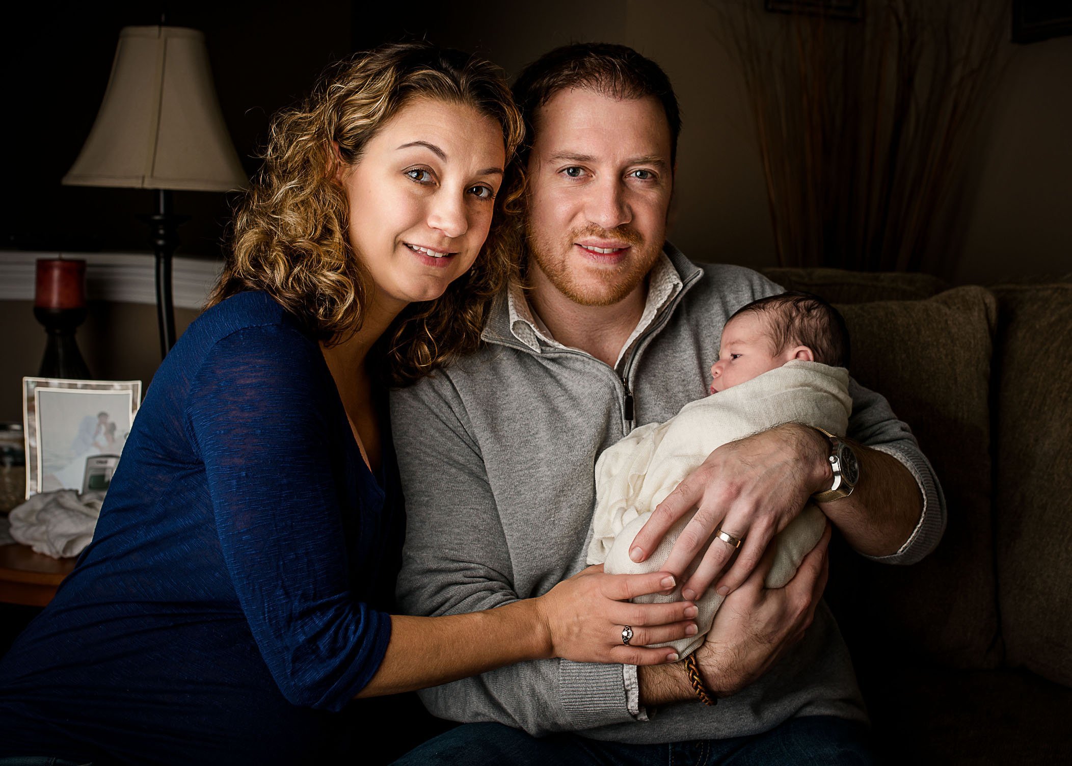 parents holding first newborn baby in arms One Big Happy Photo Amber Sehrt