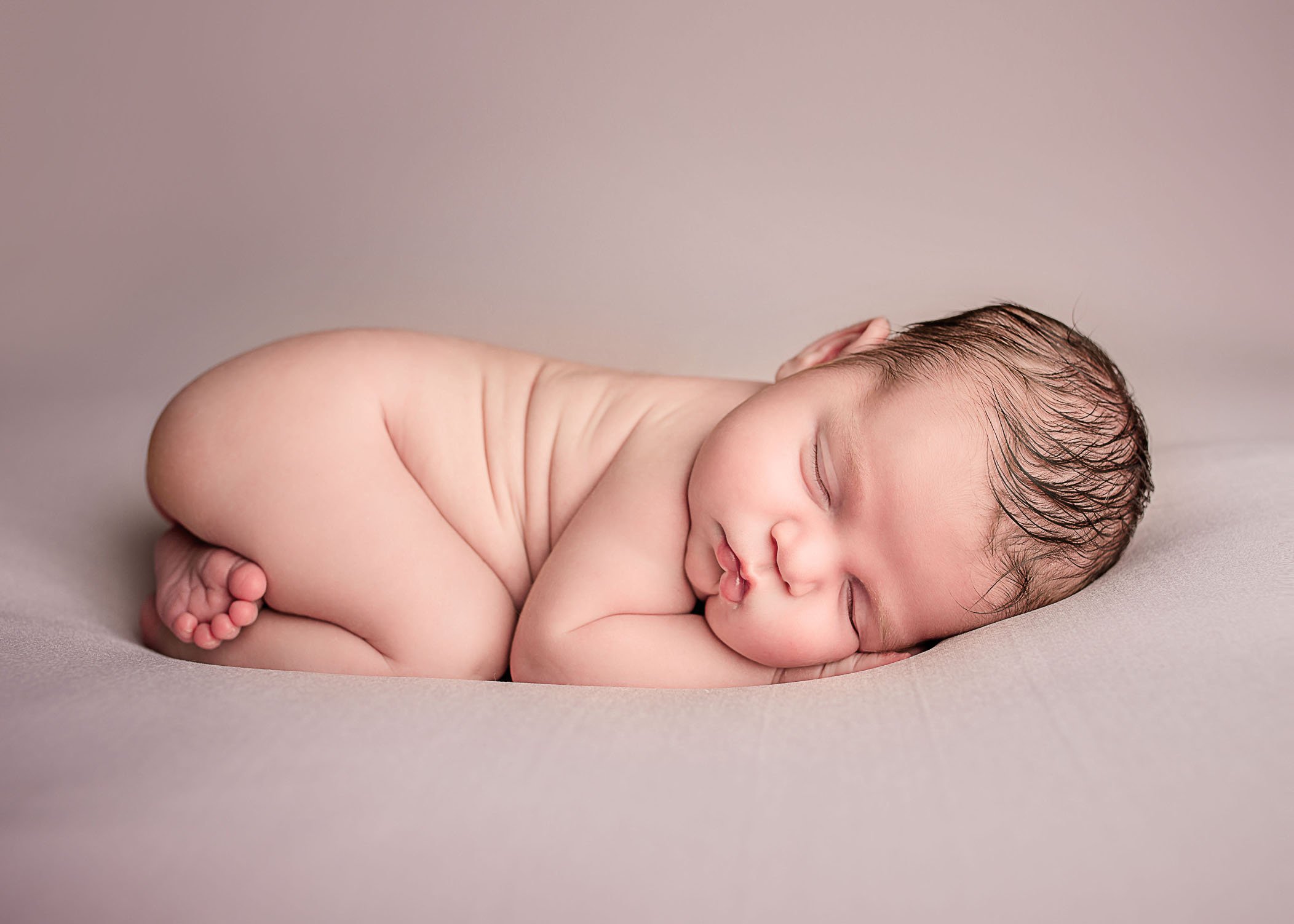 newborn baby girl sleeping on tummy on pink One Big Happy Photo Amber Sehrt