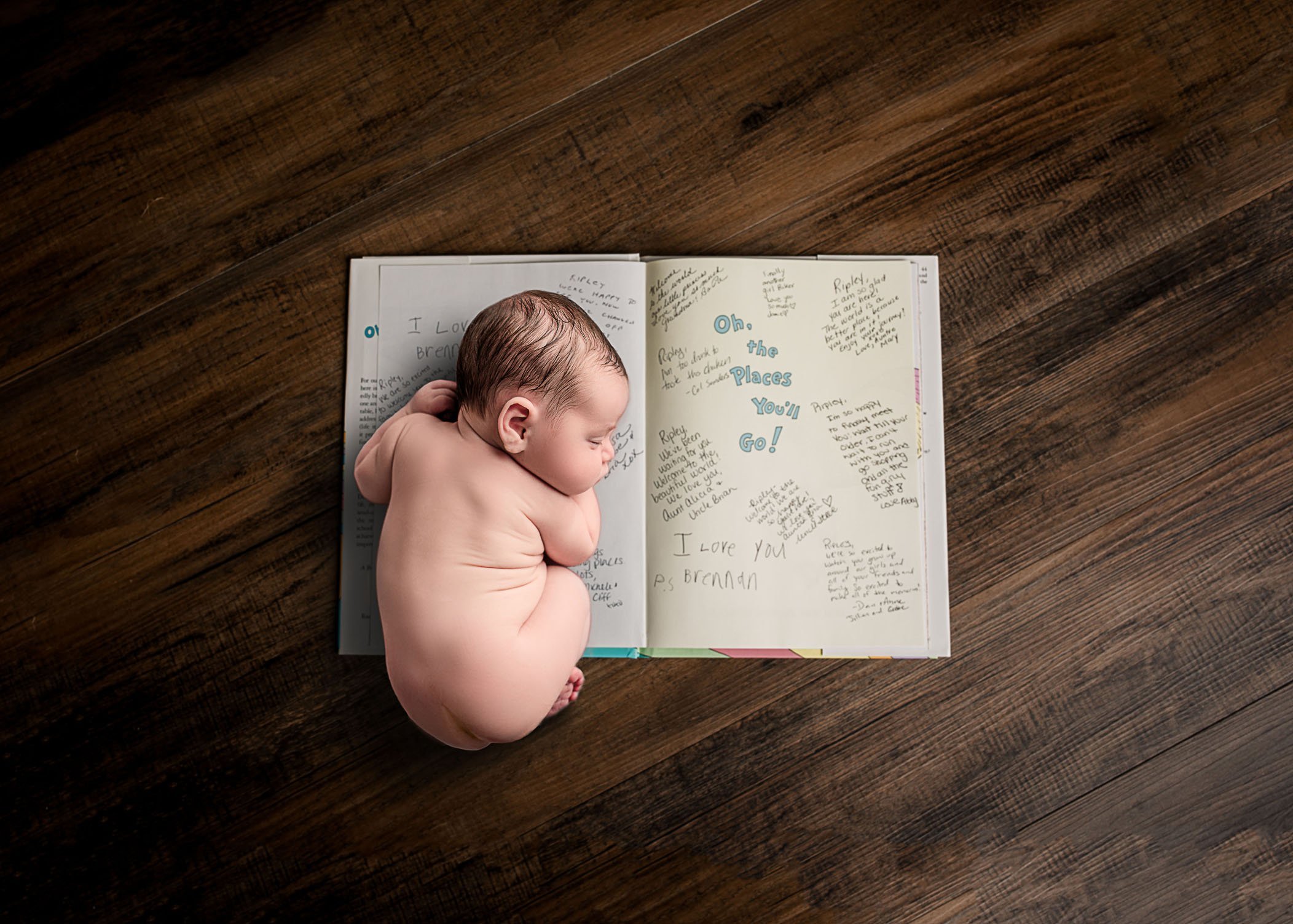 newborn baby photo sleeping on book One Big Happy Photo Amber Sehrt