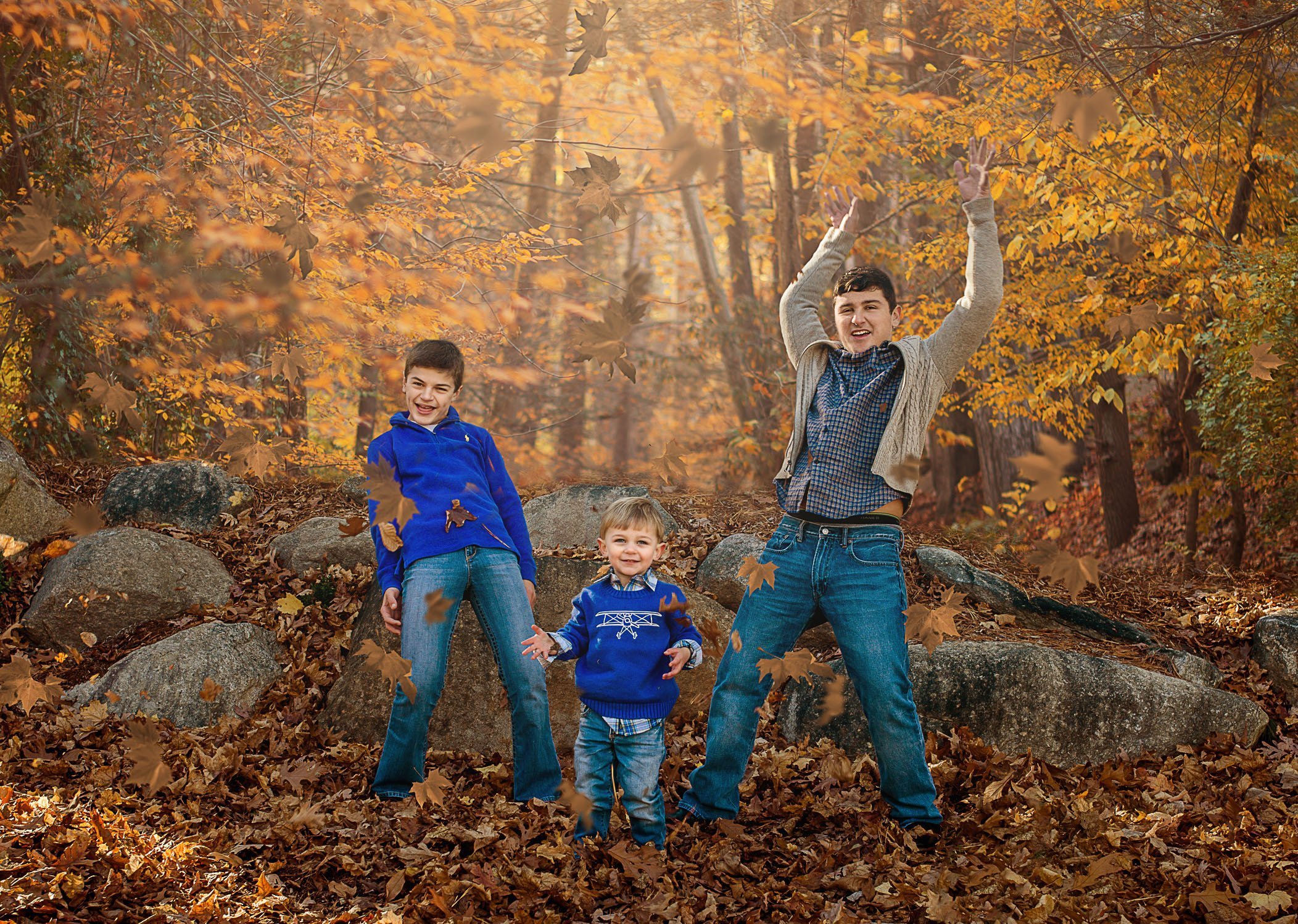 3 brothers throwing fall leaves in the air One Big Happy Photo