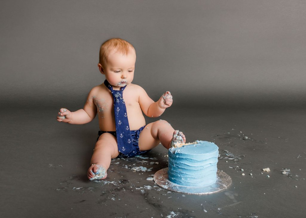 baby with feet in cake One Big Happy Photo