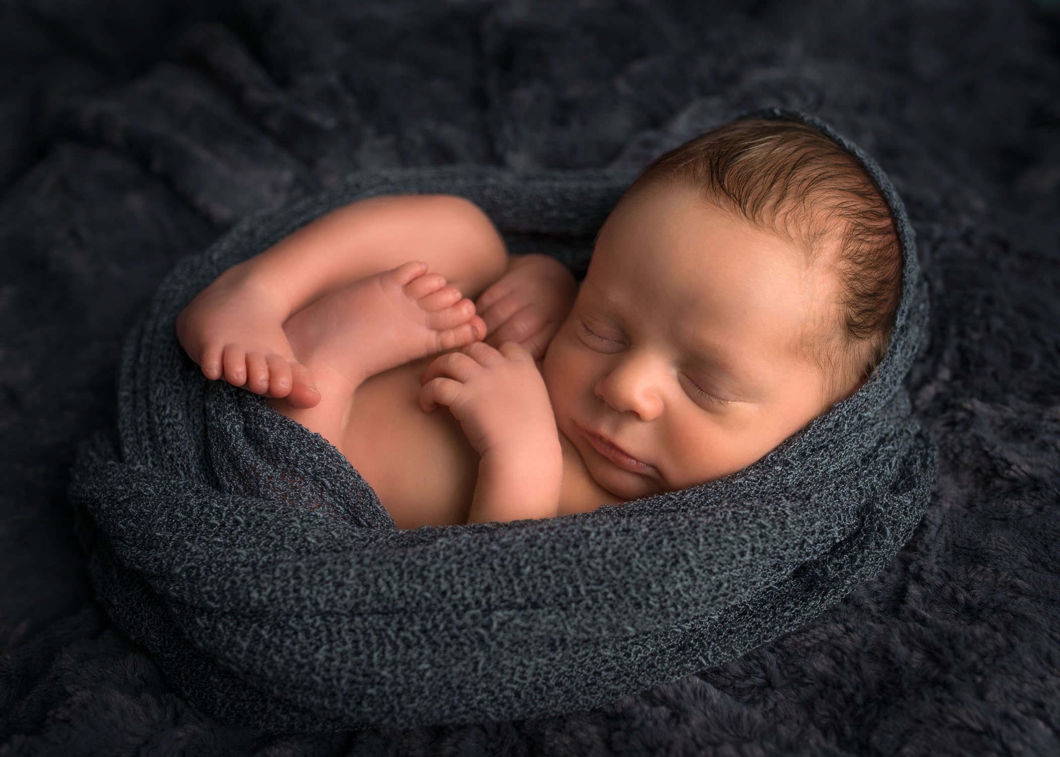 newborn sleeping in an egg wrap One Big Happy Photo