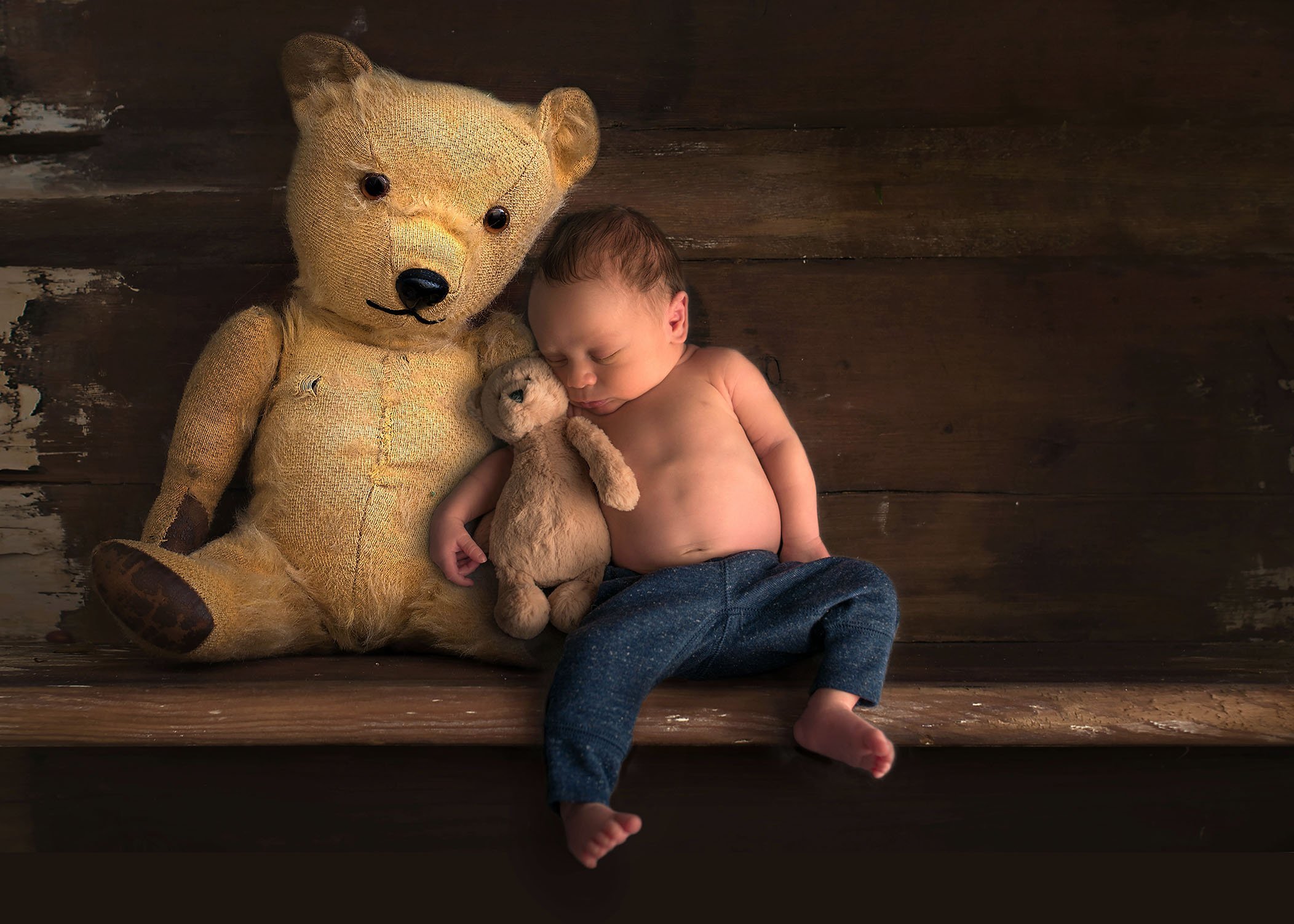 Newborn sleeping with teddy bears on a shelf One Big Happy Photo