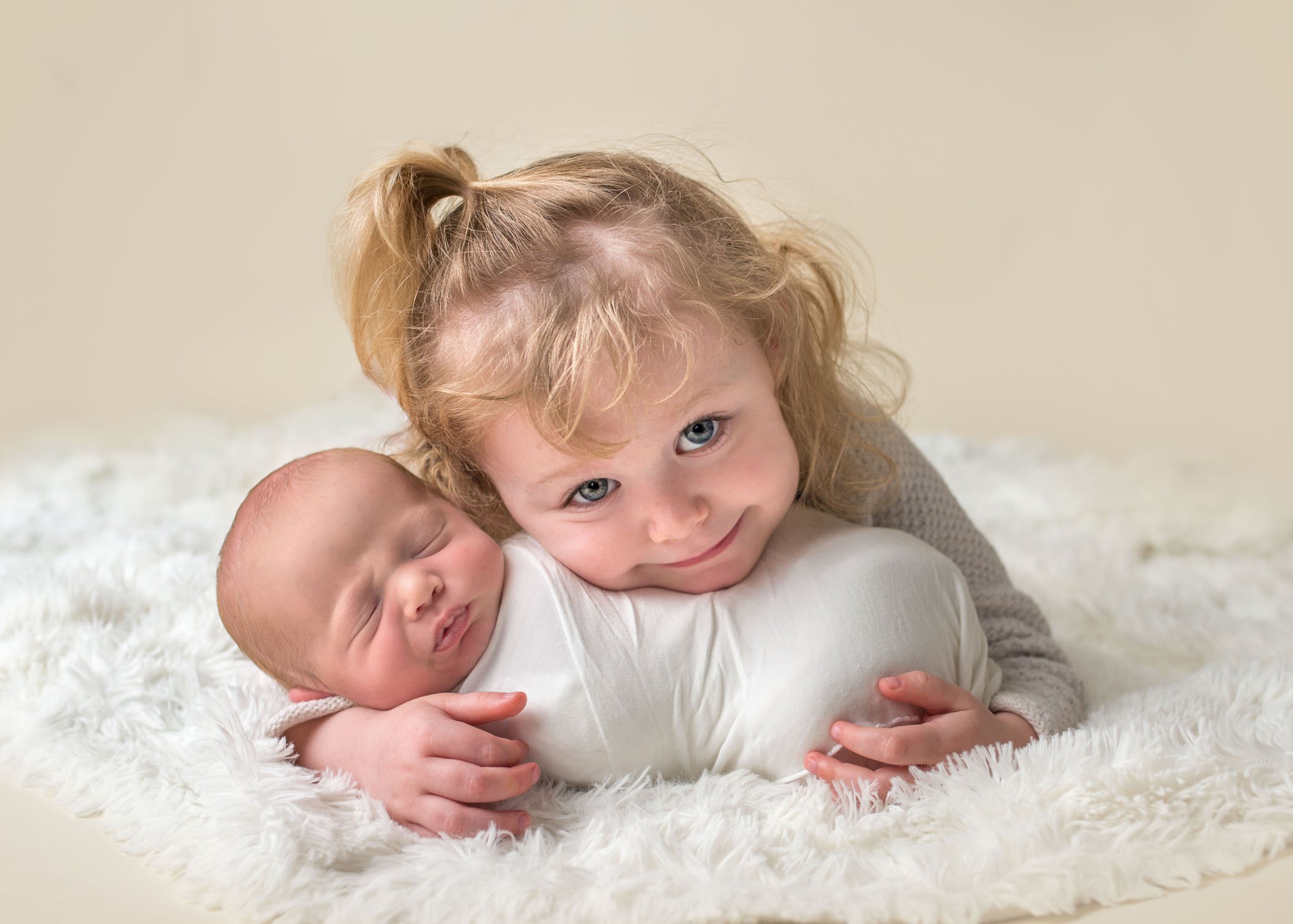 2 year old sister holding her newborn baby brother One Big Happy Photo
