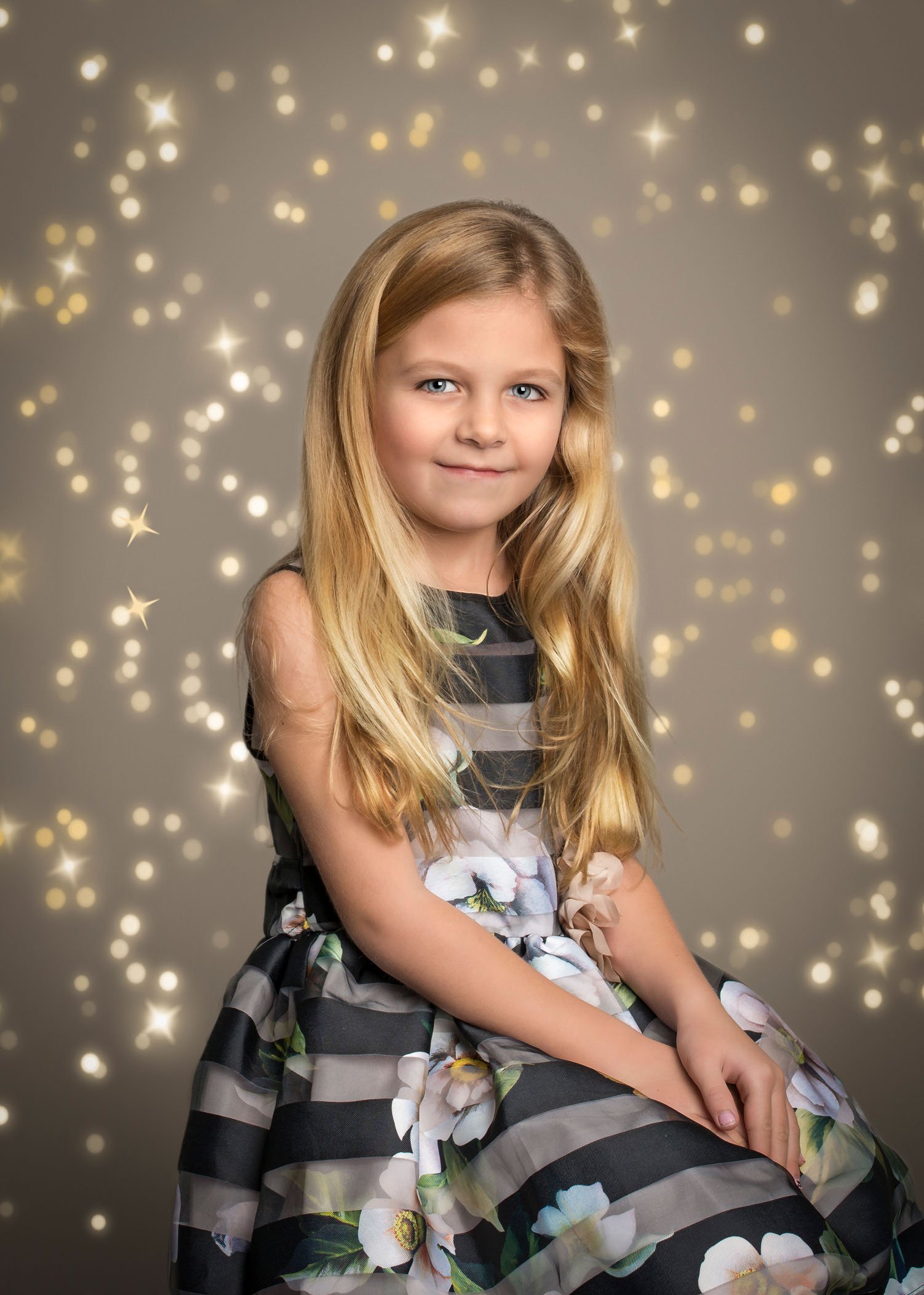 7 year old girl in pretty dress with bokeh lights
