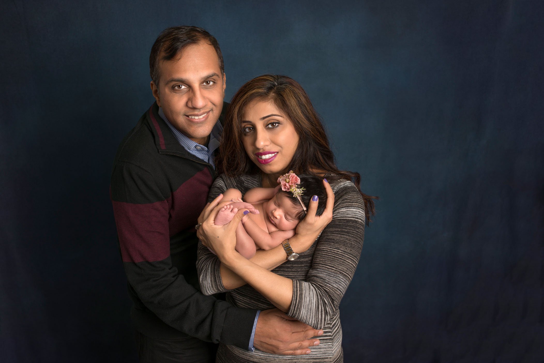 Indian mom, dad and newborn baby girl in arms