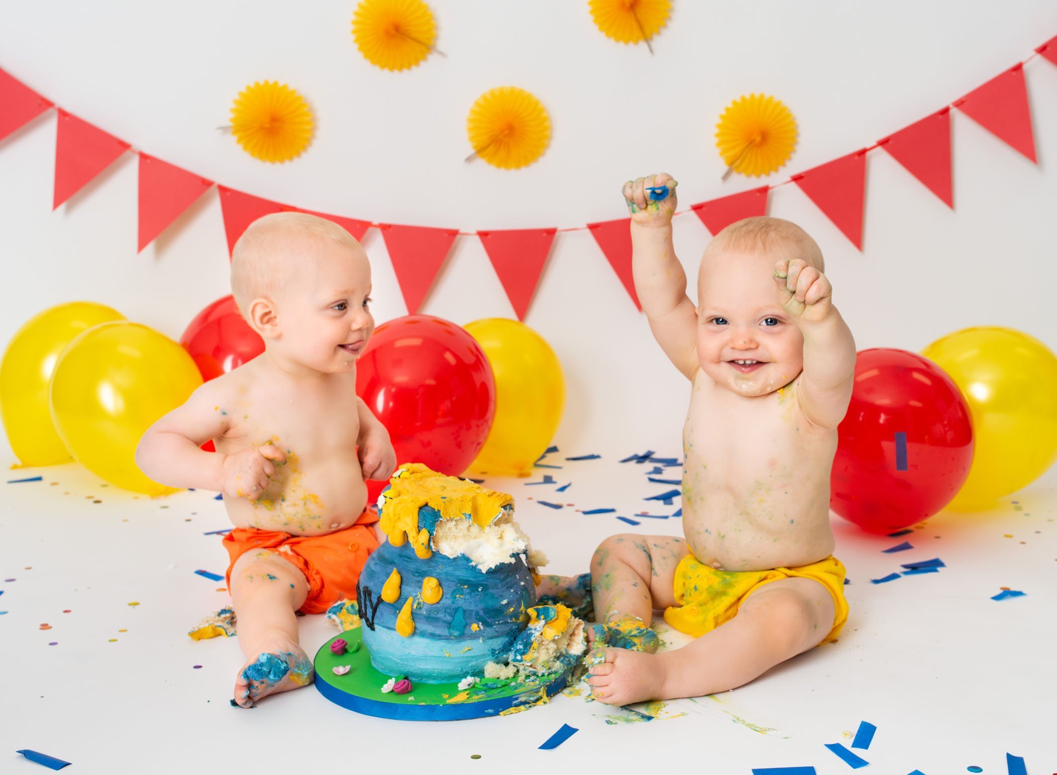 Twin 1 year old boys messy after smashing their Winnie the Pooh cake