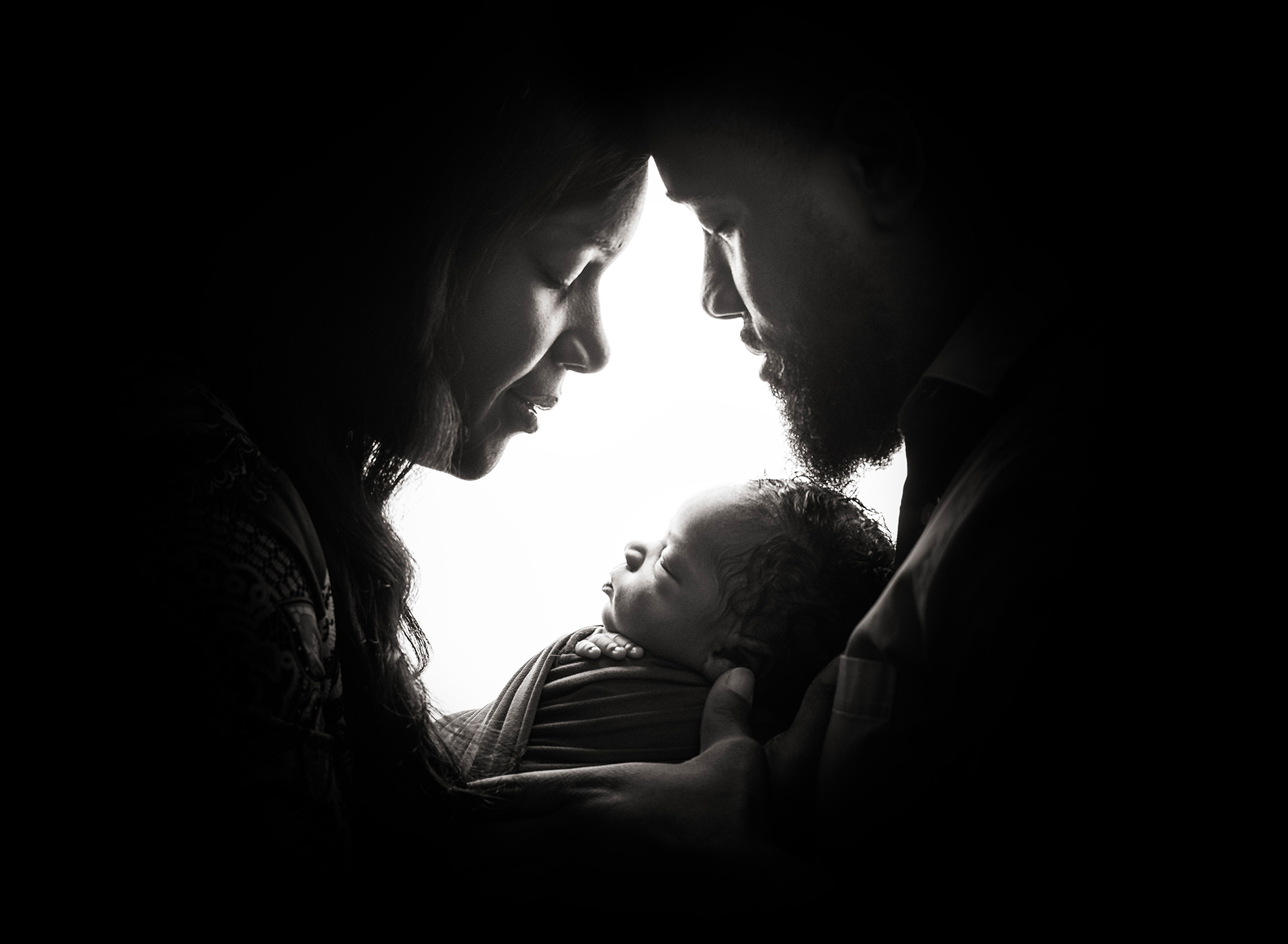 newborn photo studio mom dad and baby heads together