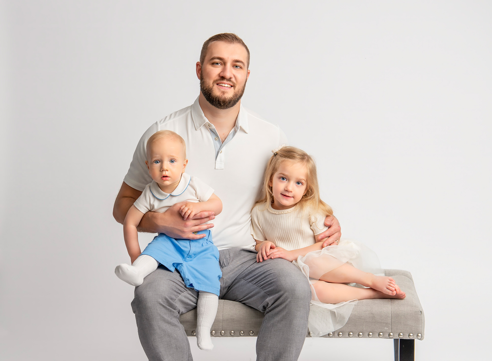 All White Baby Milestone Smash Photoshoot Dad with 2 kids on a white background