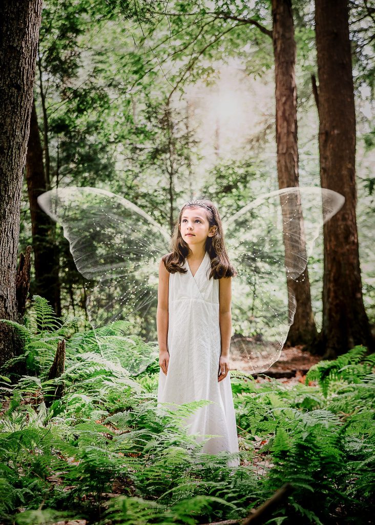 little brown haired girl fairy in the woods