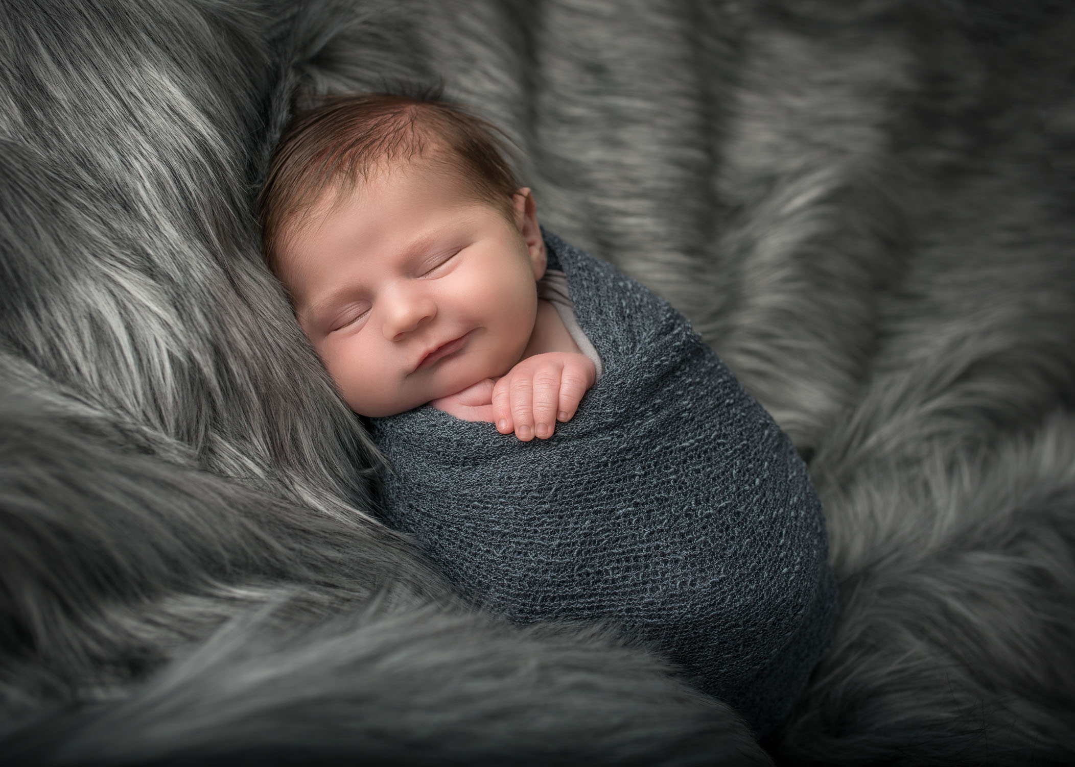 Connecticut newborn photographer baby sleeping on grey fur