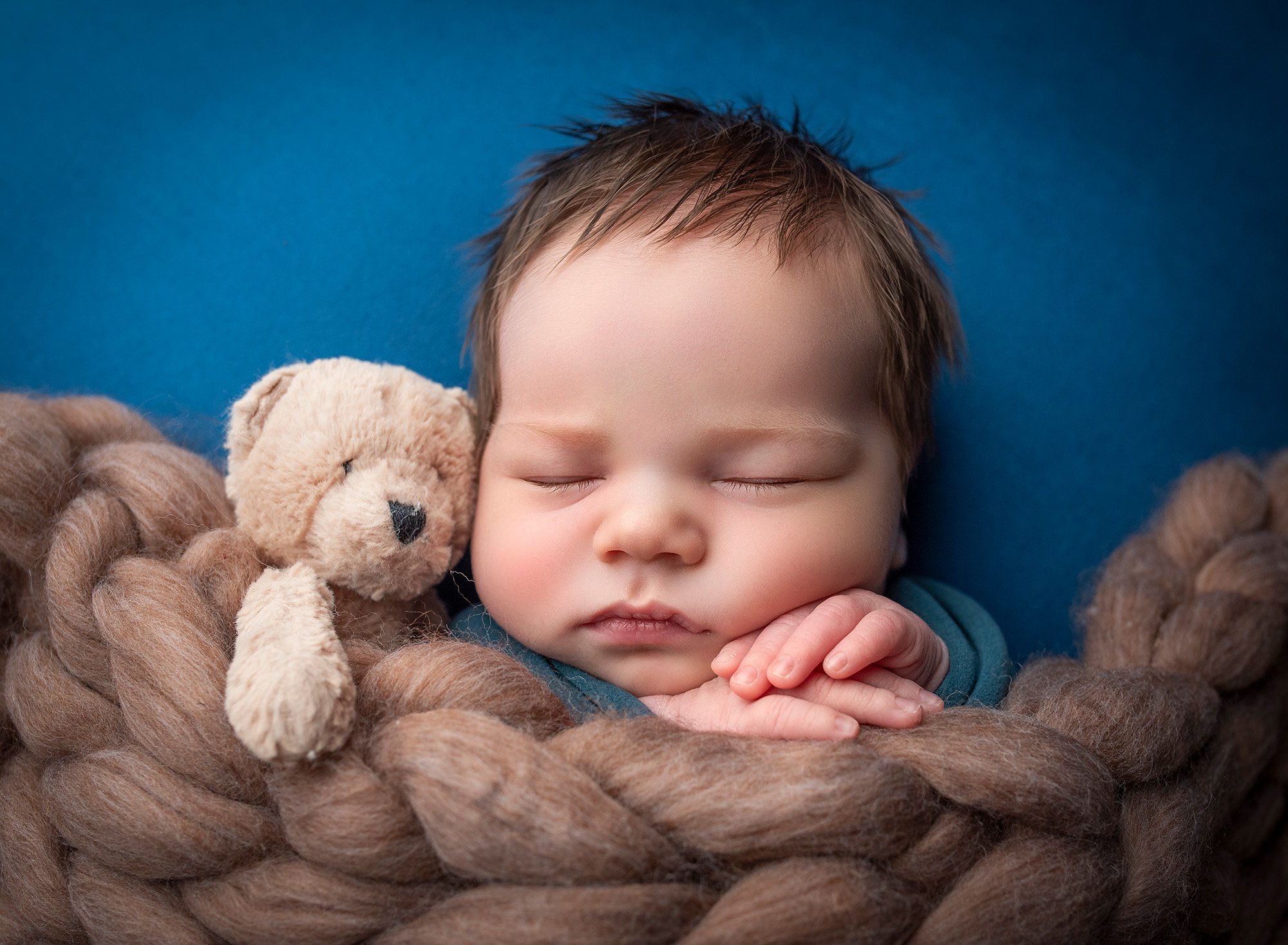 Connecticut Newborn Photography newborn baby boy asleep tucked under fluffy brown blanket with teddy bear