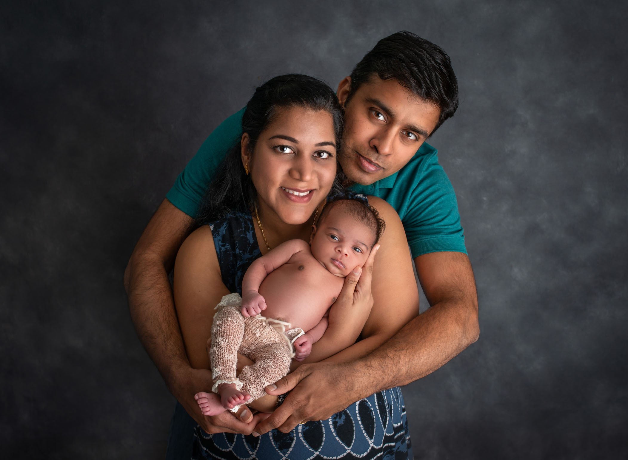 Mom Dad and newborn daughter's first portrait together