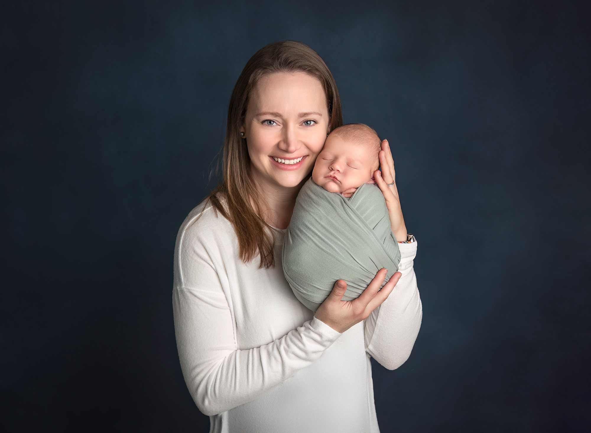 Mom cradling baby Owen against her cheek