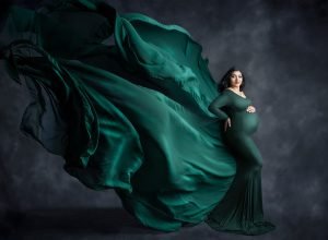 Indian Goddess Maternity photographs pregnant woman posing in green flowing maternity dress