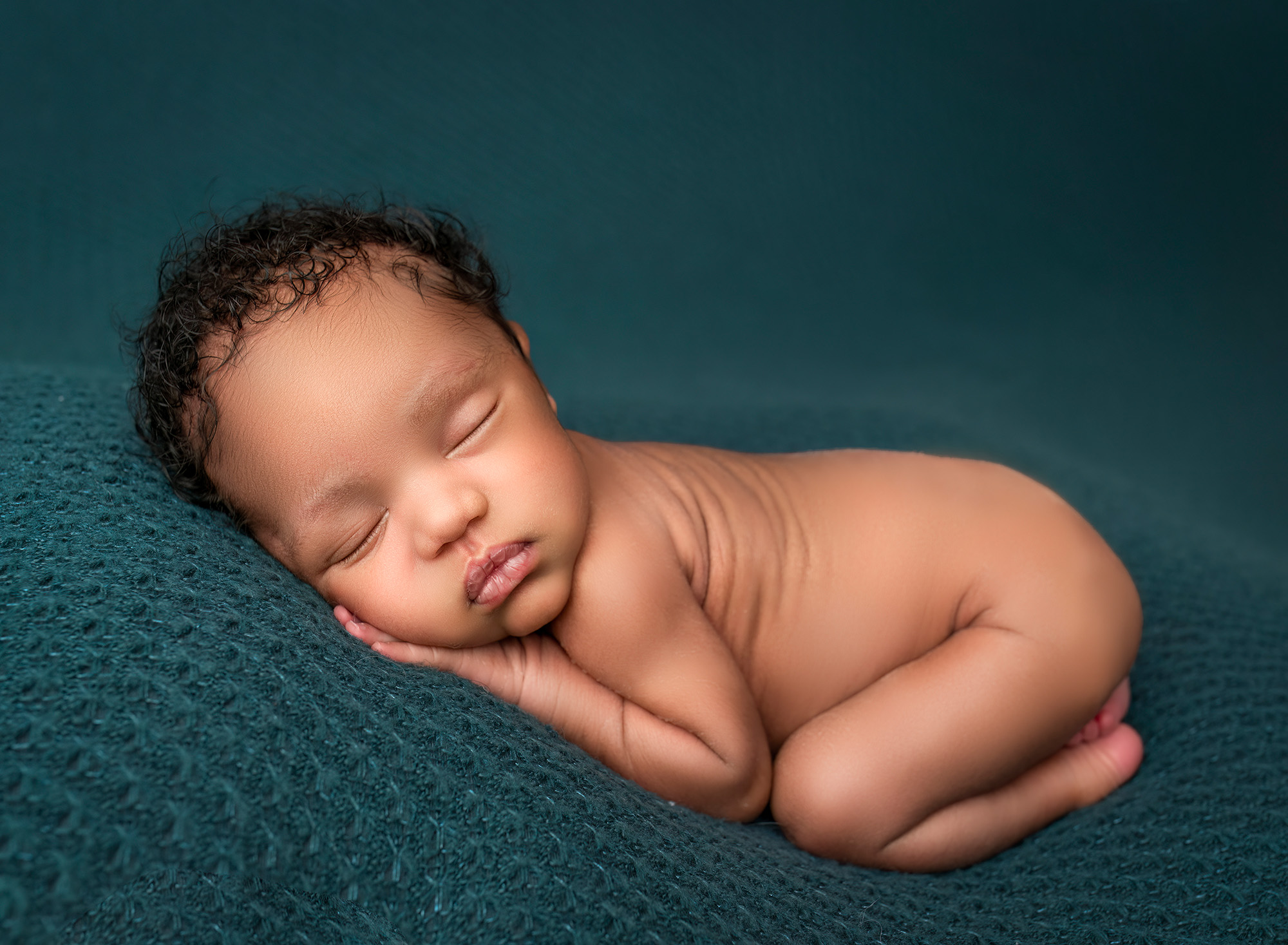 Maternity and Newborn Photographer Newborn boy asleep naked on teal fabric