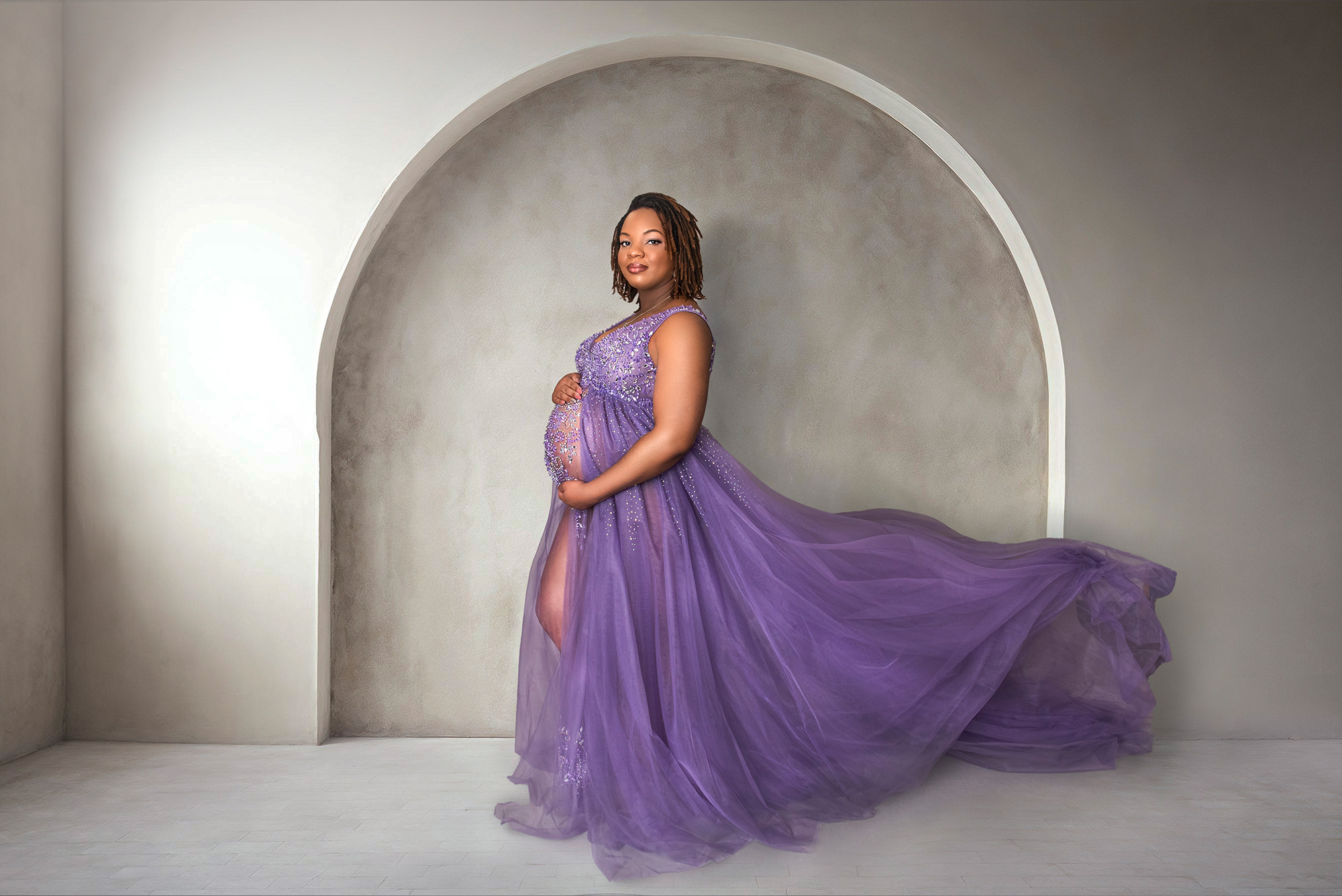 Pregnant woman wearing a purple sparkly gown