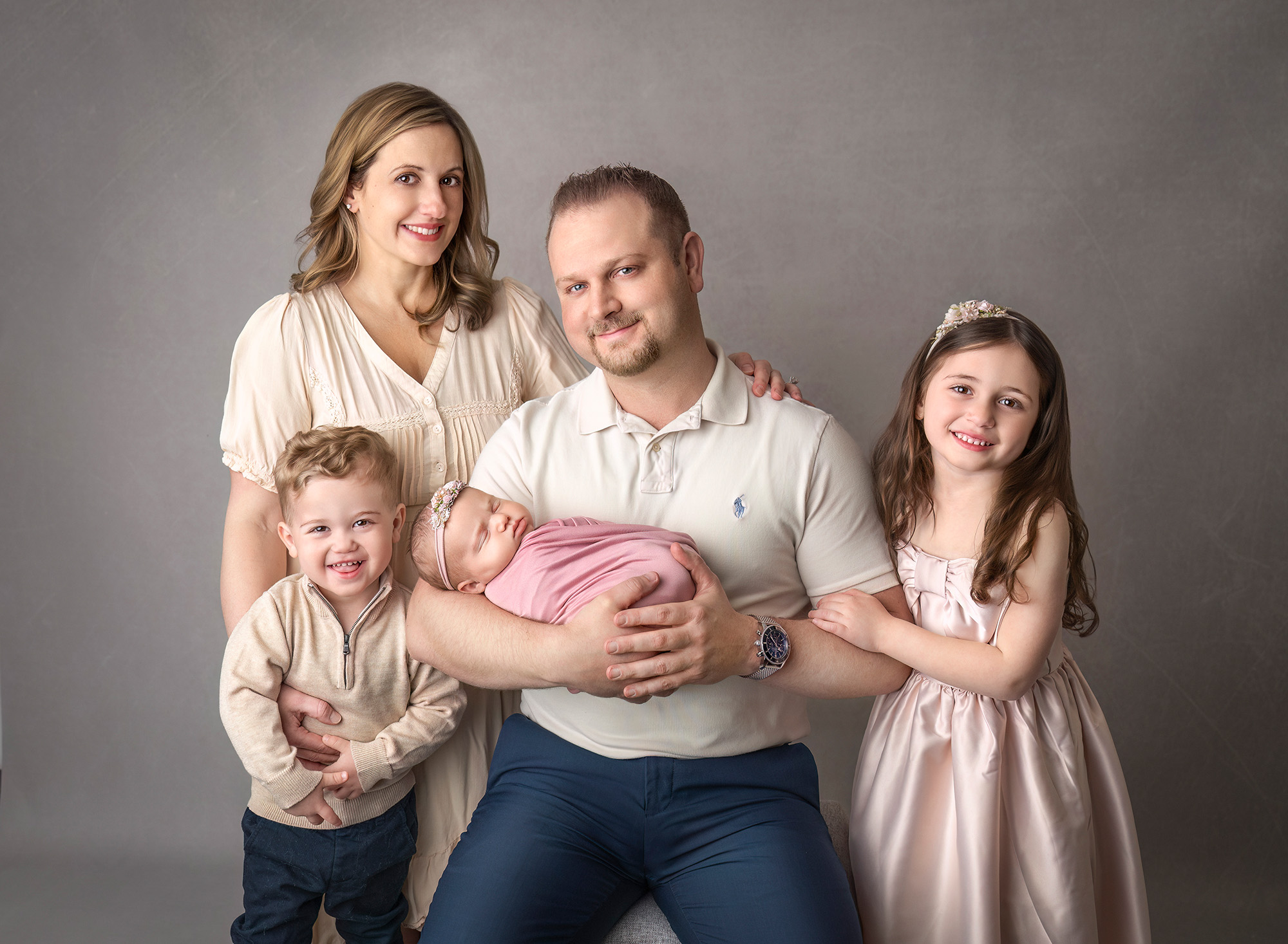 Full family portrait — Parents with Charlotte, Mason, and Mia in coordinated pastels.