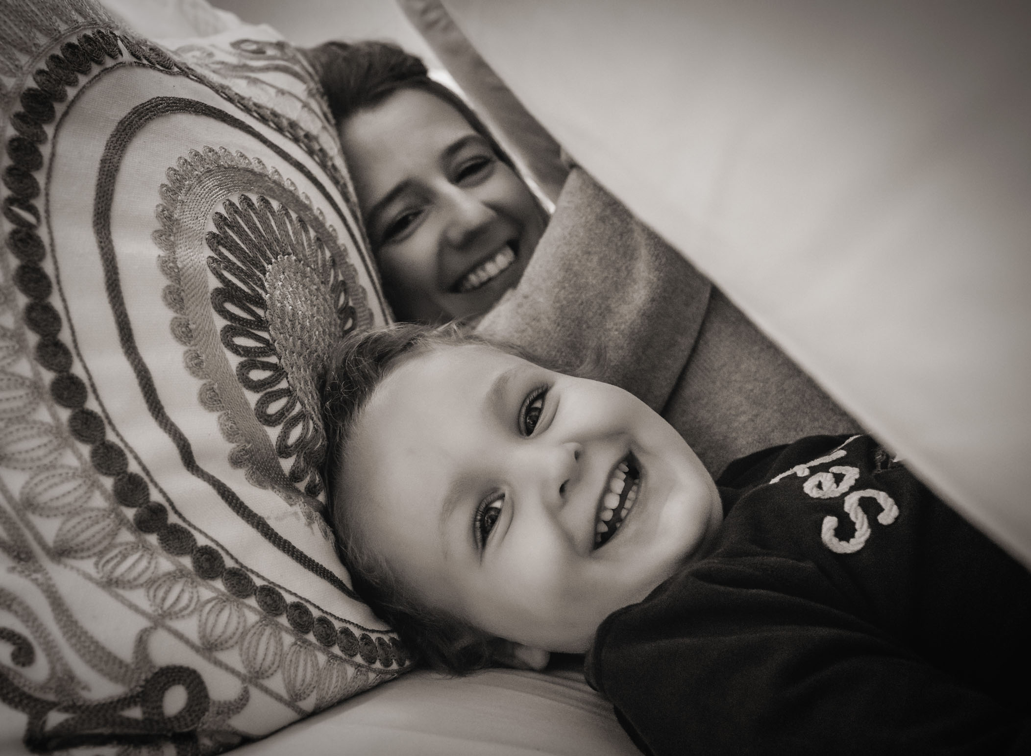Mom and son playing under the covers