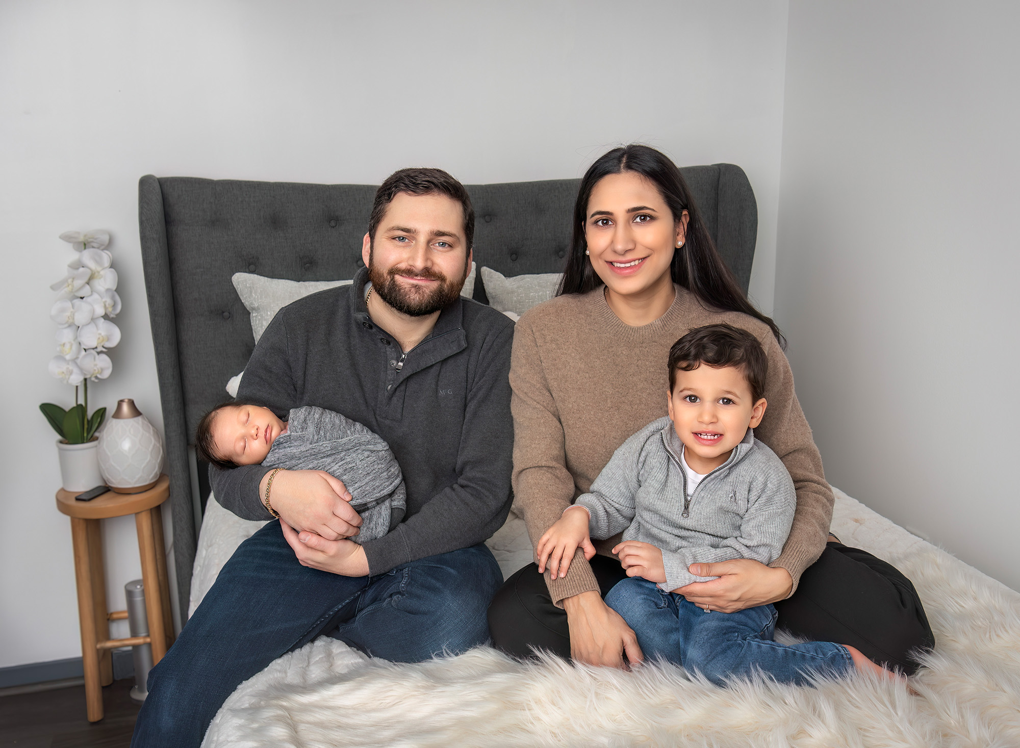 Newborn Family Photography Family smiling with newborn baby boy in dad’s arms