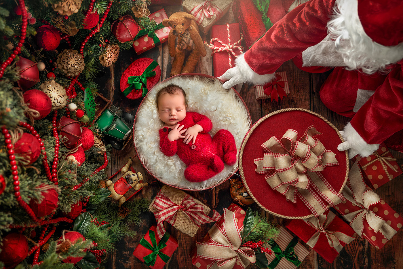 a whimsical scene of Santa leaving baby Joseph as a present under the Christmas tree
