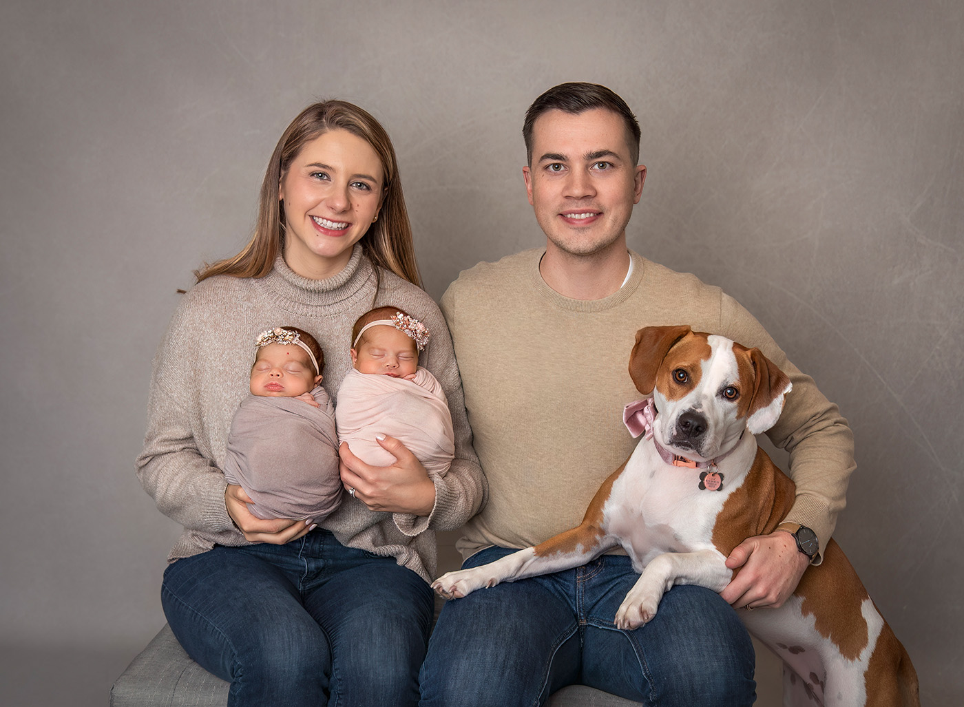 family portrait of newborn twin photography twin baby girls with mom and dad and their brown and white dog