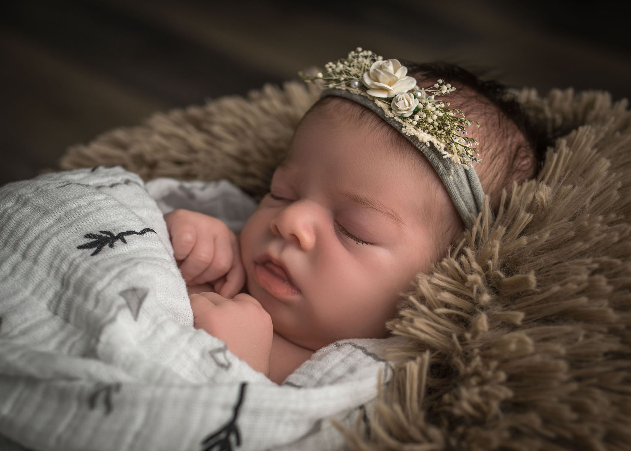 sleeping newborn baby girl with floral headband
