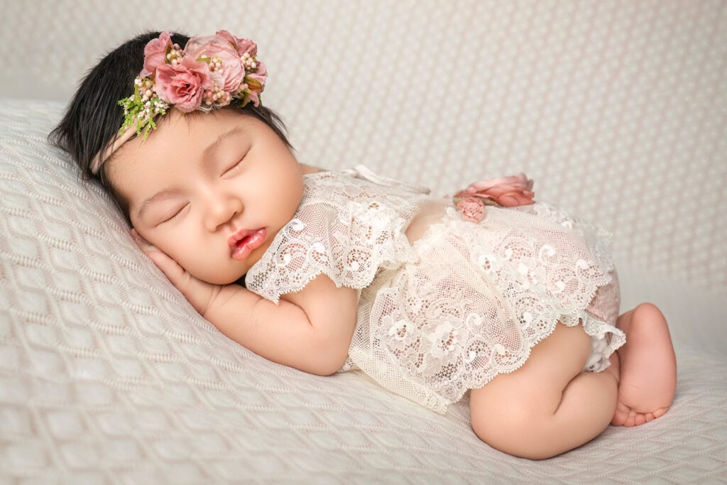 Connecticut newborn photographer baby sleeping on her tummy in a lace outfit