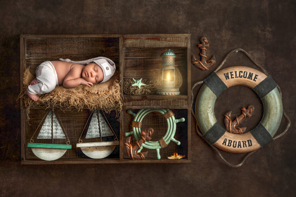 what is the best time for newborn photoshoot newborn sleeping on crate with welcome aboard ring