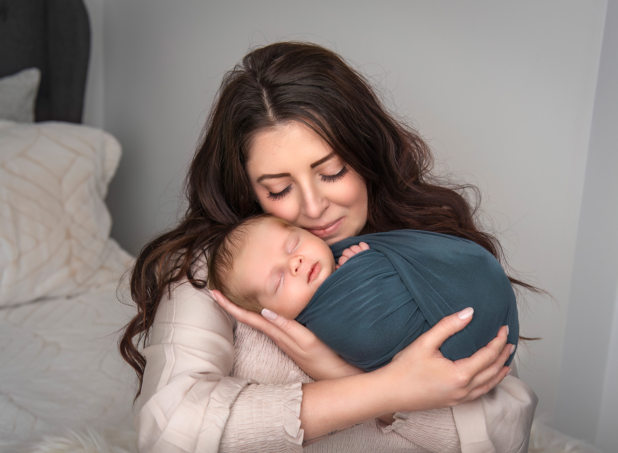 Mom cradling newborn baby boy in a sweet embrace