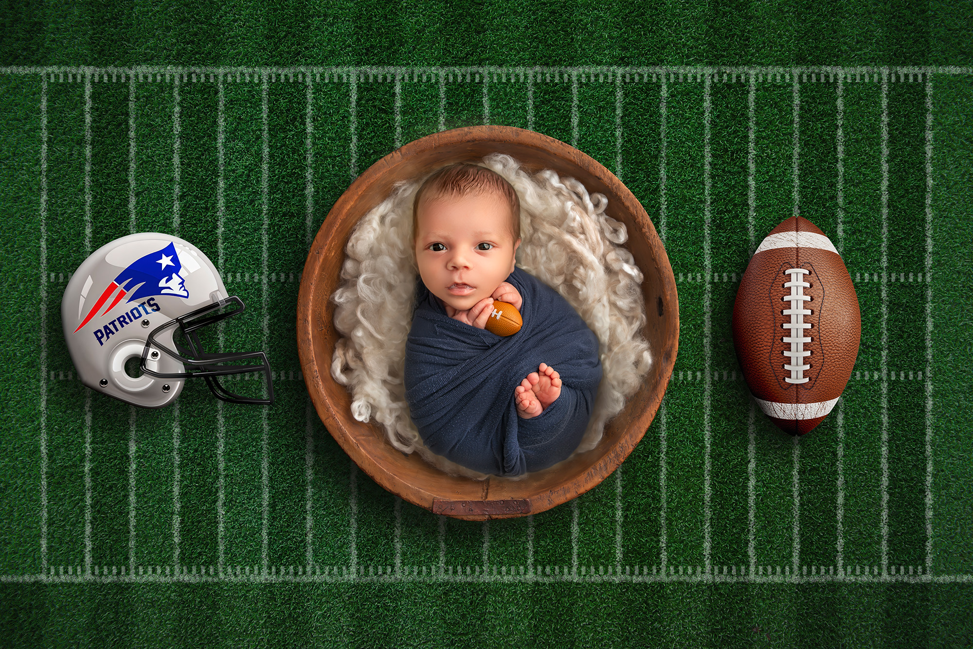Best time for newborn photos awake baby boy wrapped with football