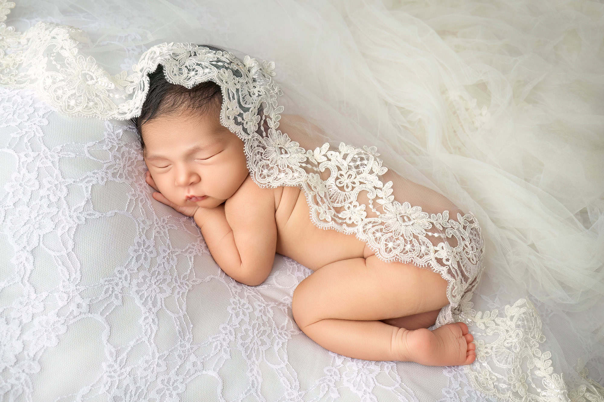 CT peaceful newborn session newborn baby draped in a lace wedding veil