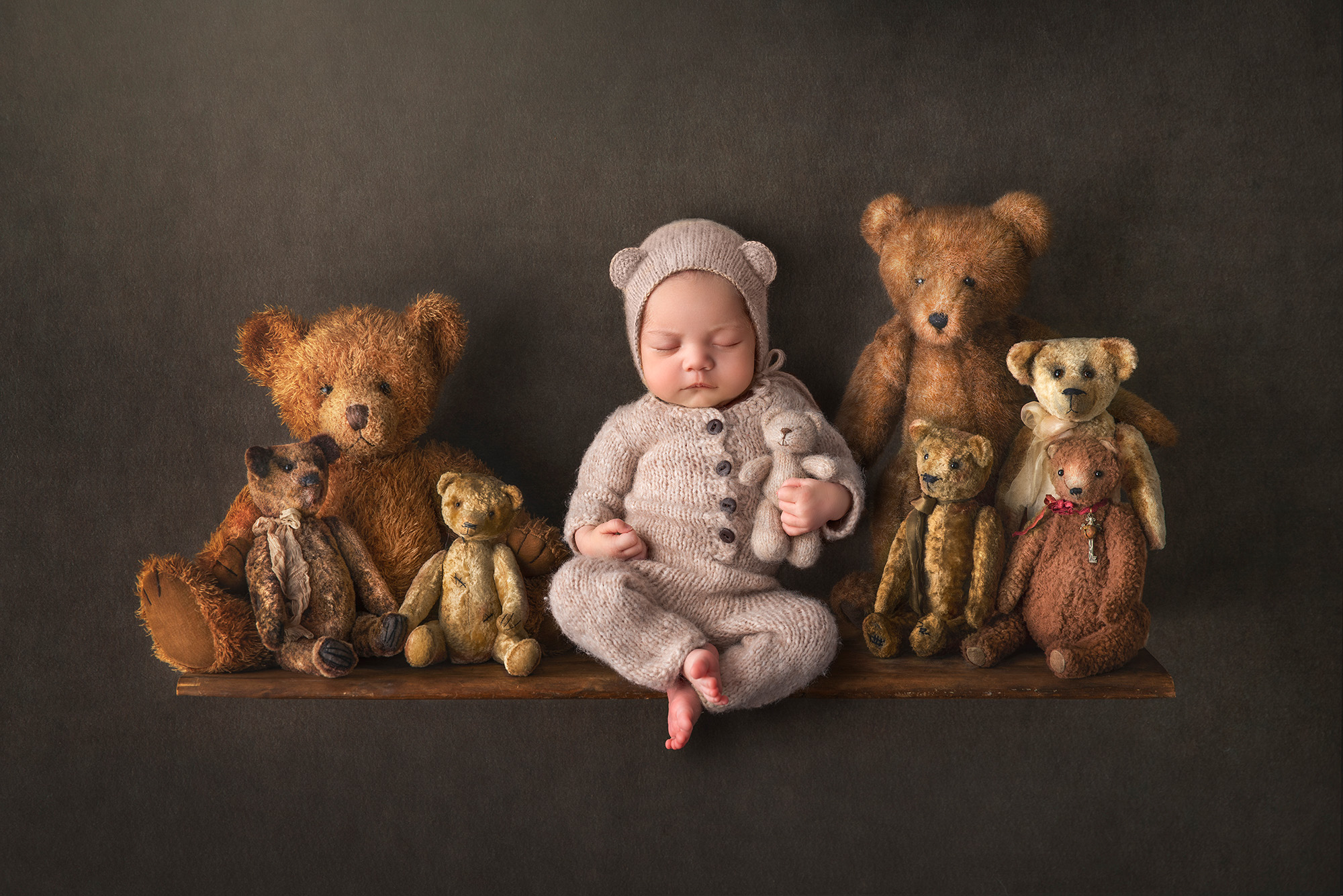 when should you take newborn photos little boy dressed up as teddy bear sleeping