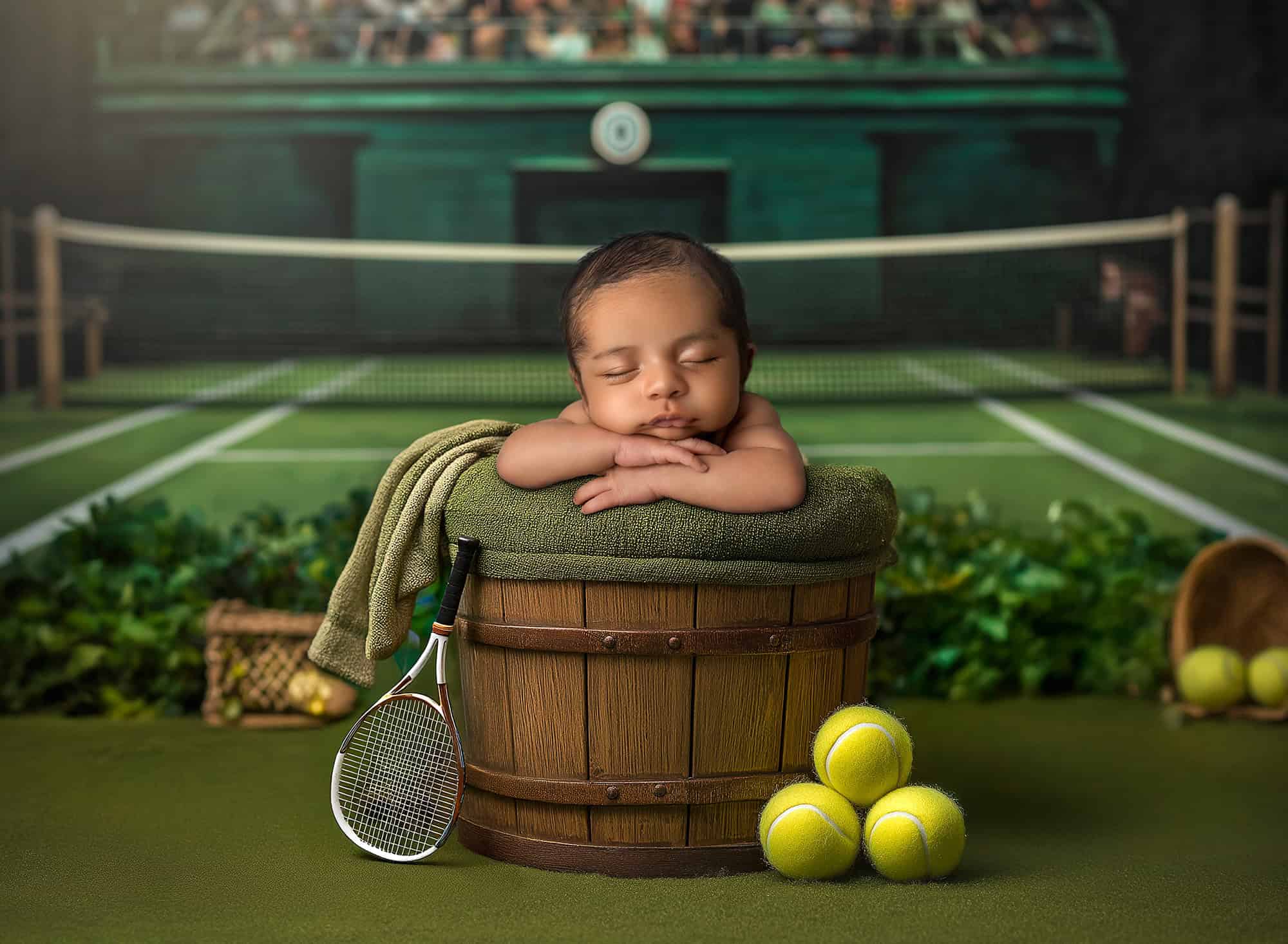 Glastonbury newborn photographer newborn baby sleeping in a bucket on a tennis court