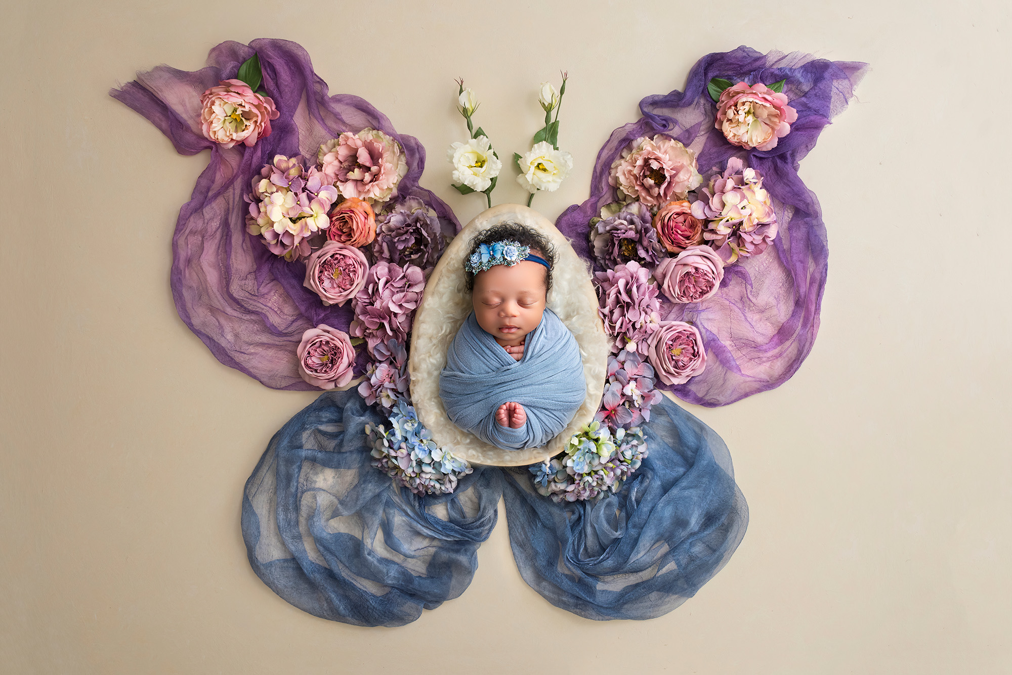 best time to take newborn photos baby girl in center of butterfly