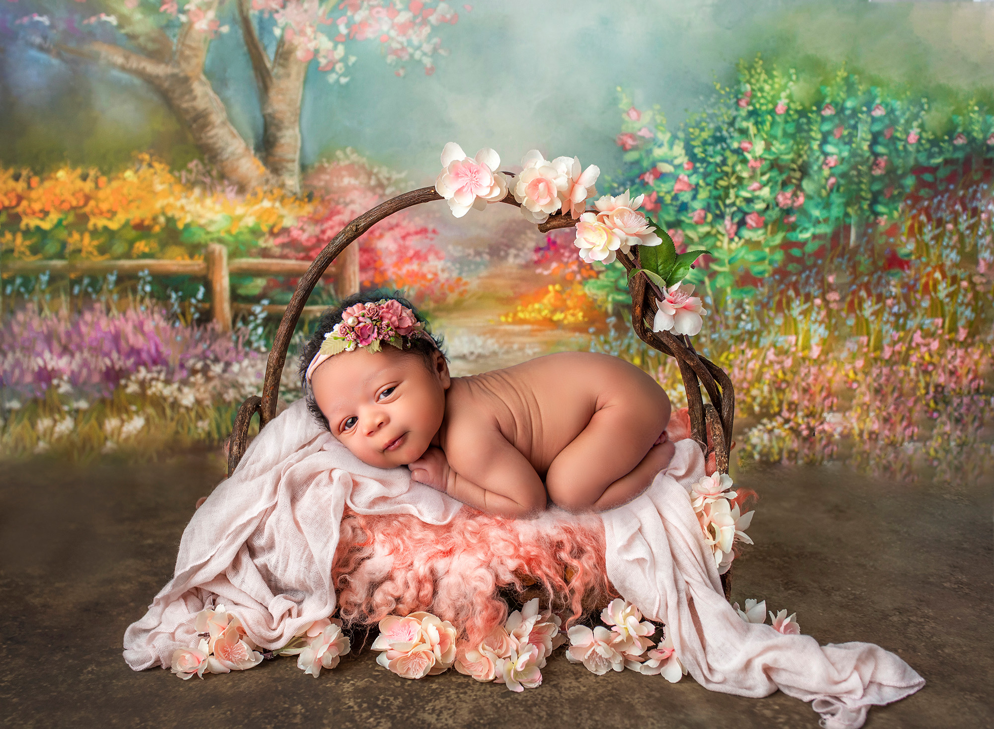 when to do newborn photos baby girl resting on floral bed